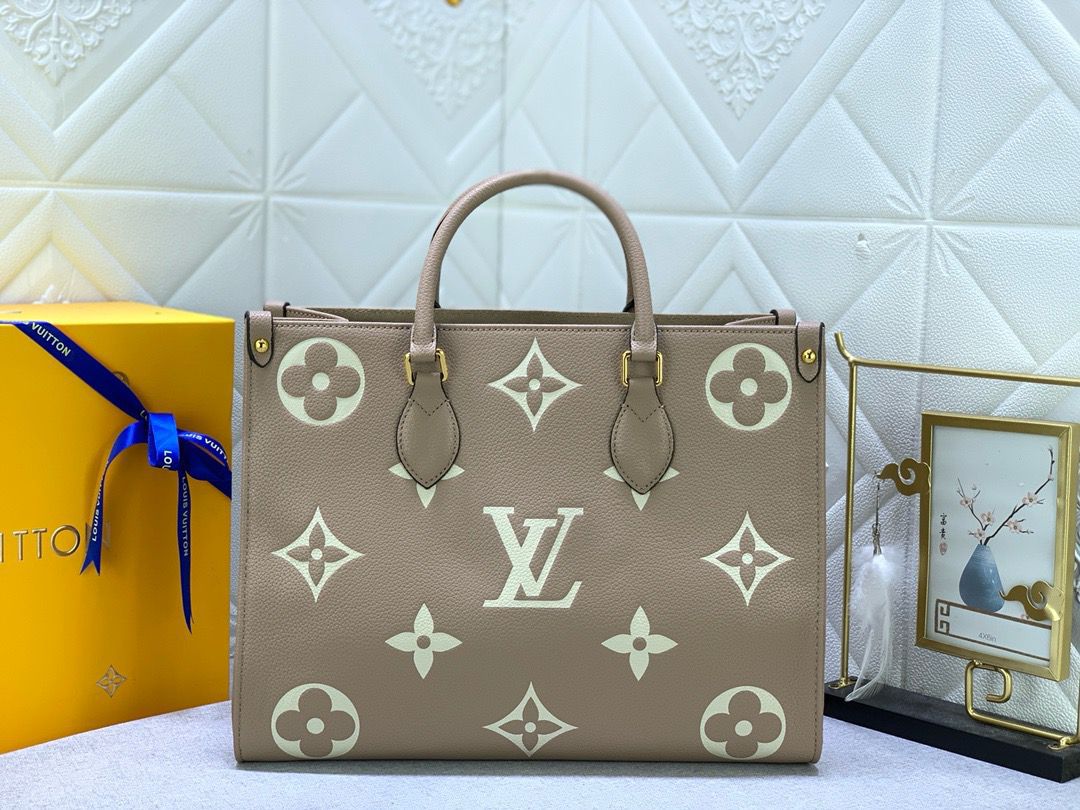 Louis Vuitton OnTheGo MM tote bag in two-tone Monogram Empreinte embossed grained cowhide leather in the Tourterelle Cr?me (dove grey/greige) and cream colorway. image 1