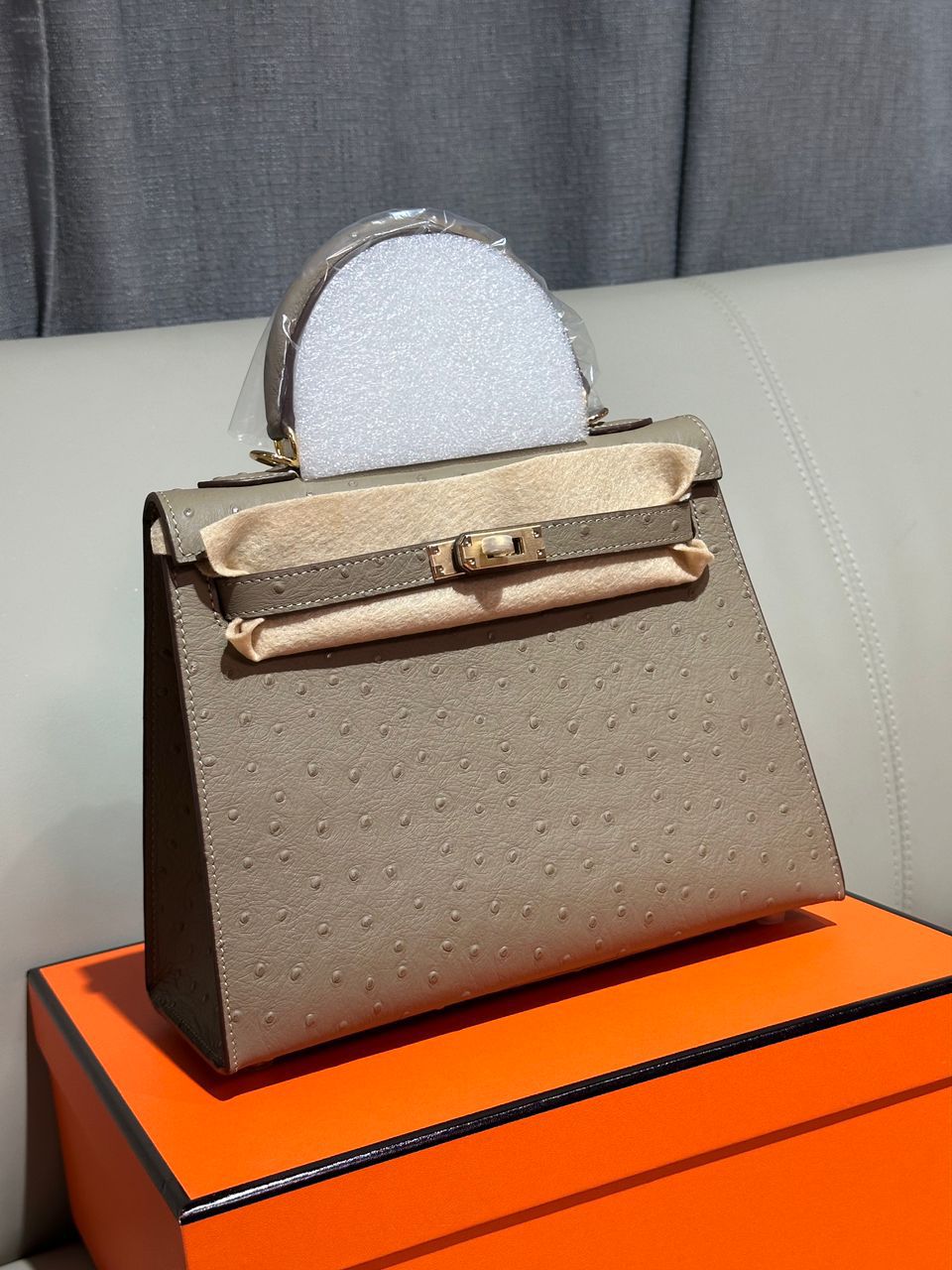 Herm?s Kelly top handle bag in light brown or etoupe ostrich leather with gold hardware. image 1
