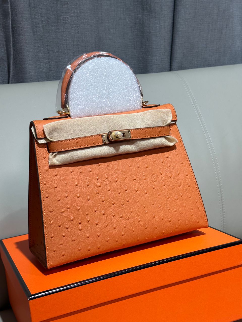 Herm?s Kelly bag in an orange ostrich-embossed leather finish. image 1