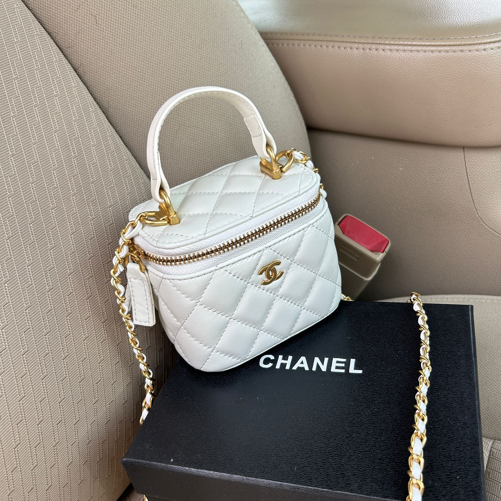 Chanel Mini Vanity Case in quilted lambskin or calfskin leather with a gold-tone chain strap. image 1