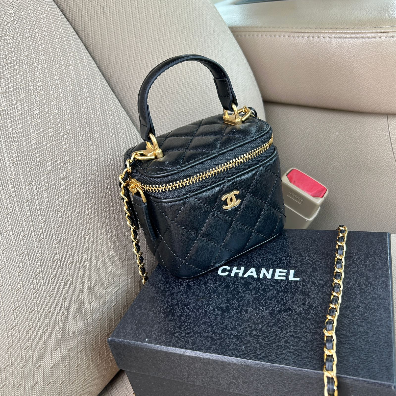 Chanel mini top handle vanity case with chain in black quilted lambskin leather. image 1