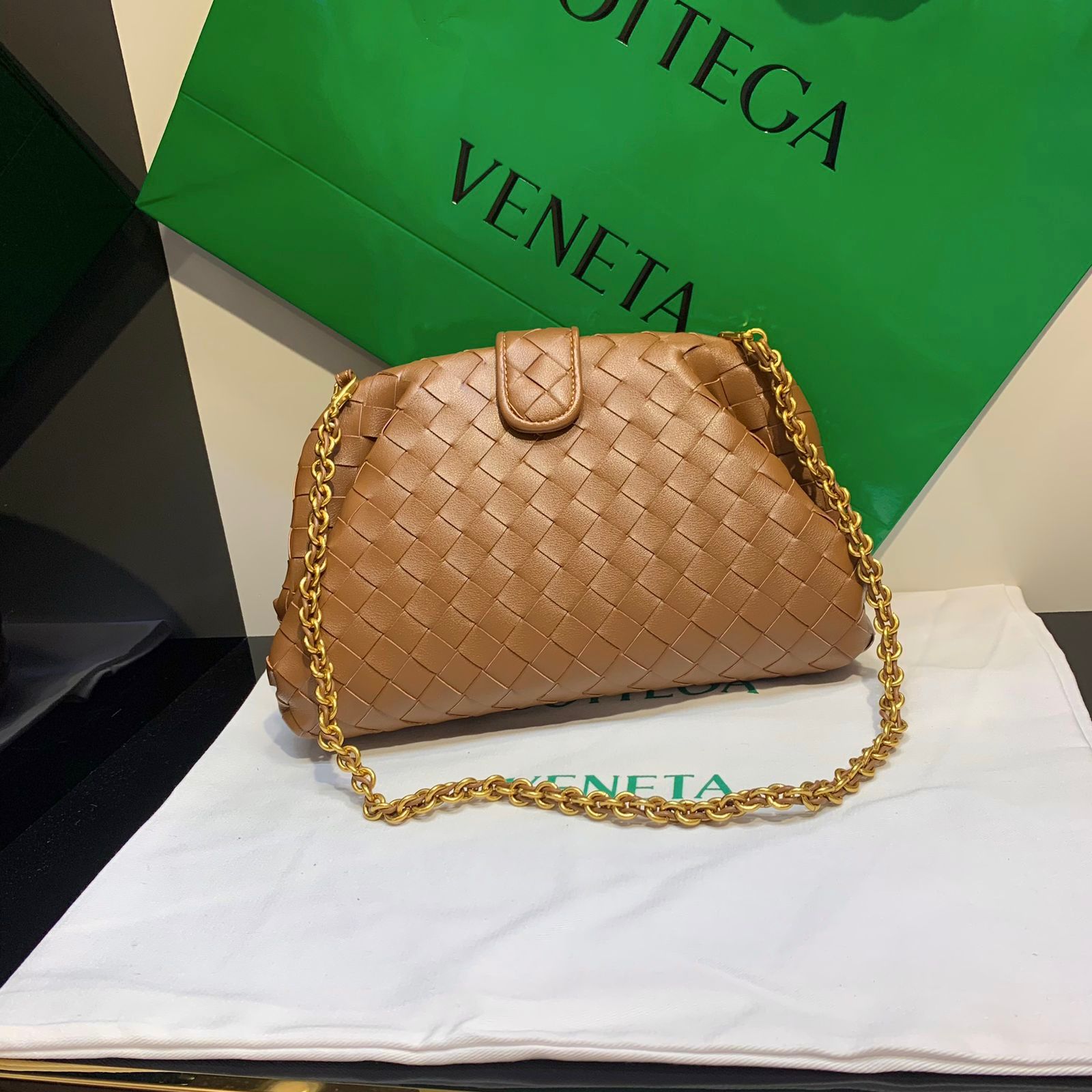 Bottega Veneta Teen Lauren 1980 clutch in brown intrecciato leather with a gold-toned chain strap. image 1