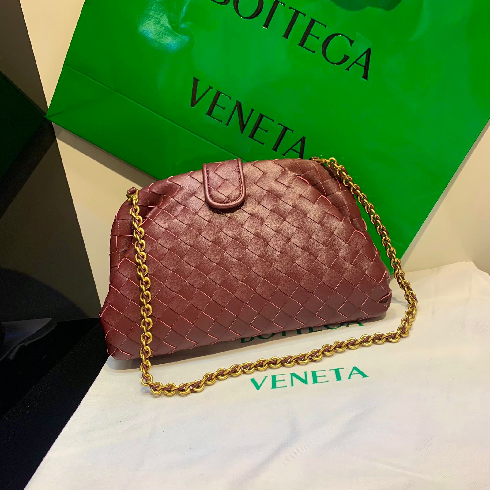 Bottega Veneta Small Lauren 1980 clutch bag in burgundy intrecciato leather with a gold-tone chain strap. image 1