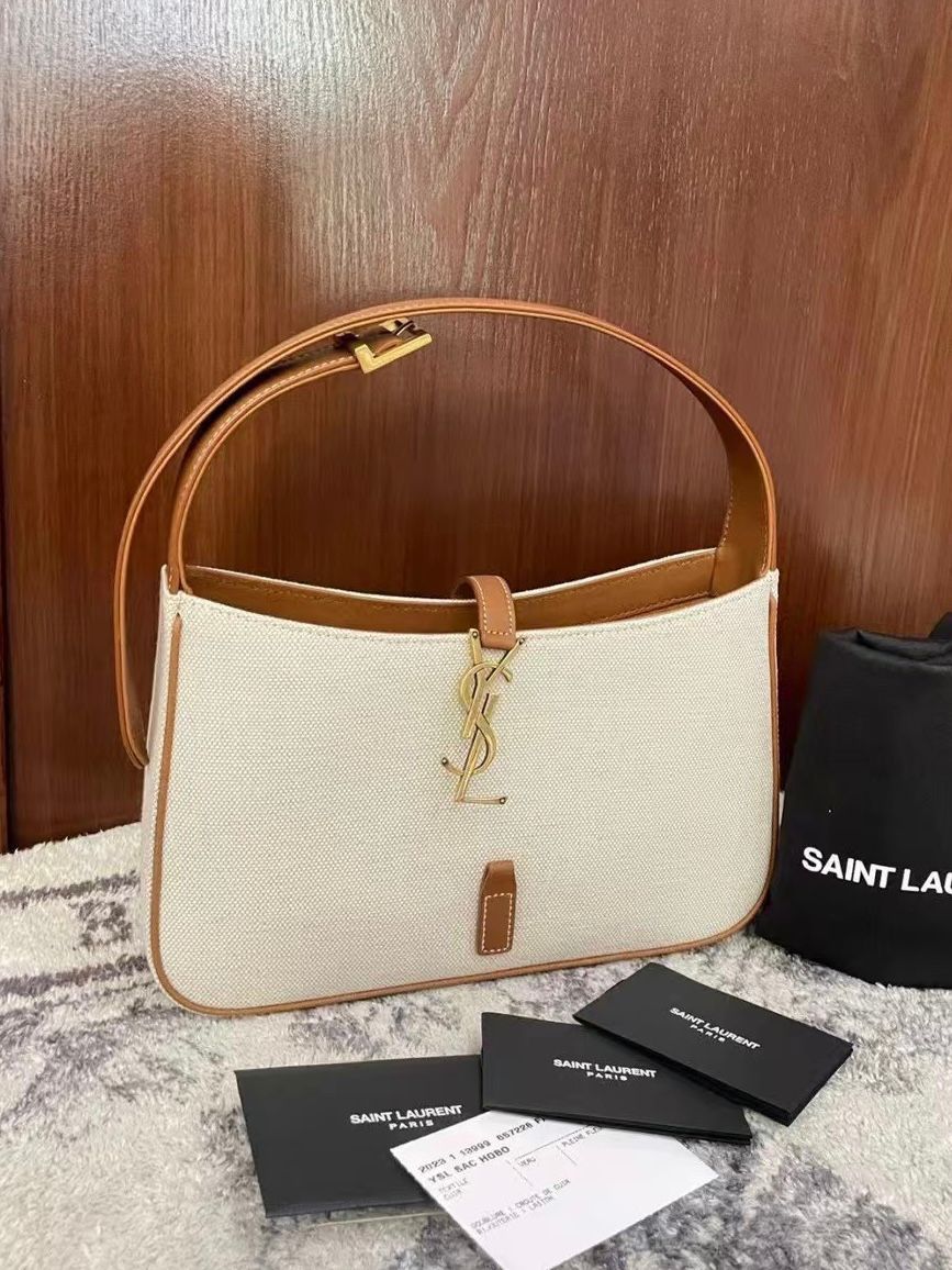 Saint Laurent Le 5 ? 7 hobo bag in ecru canvas with brown leather trim and a gold-toned YSL hook closure. image 1