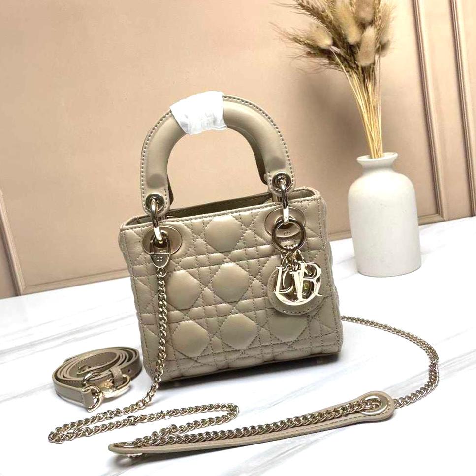 Dior Mini Lady Dior bag in powder beige lambskin with light gold-finish metal D.I.O.R. charms and a detachable chain strap. image 1
