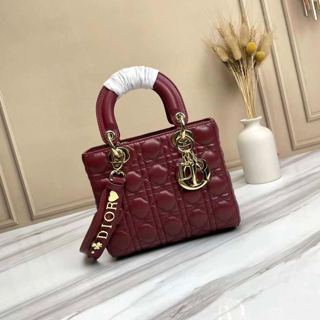 Dior Lady Dior bag in a burgundy or cherry red cannage lambskin leather finish. image 1