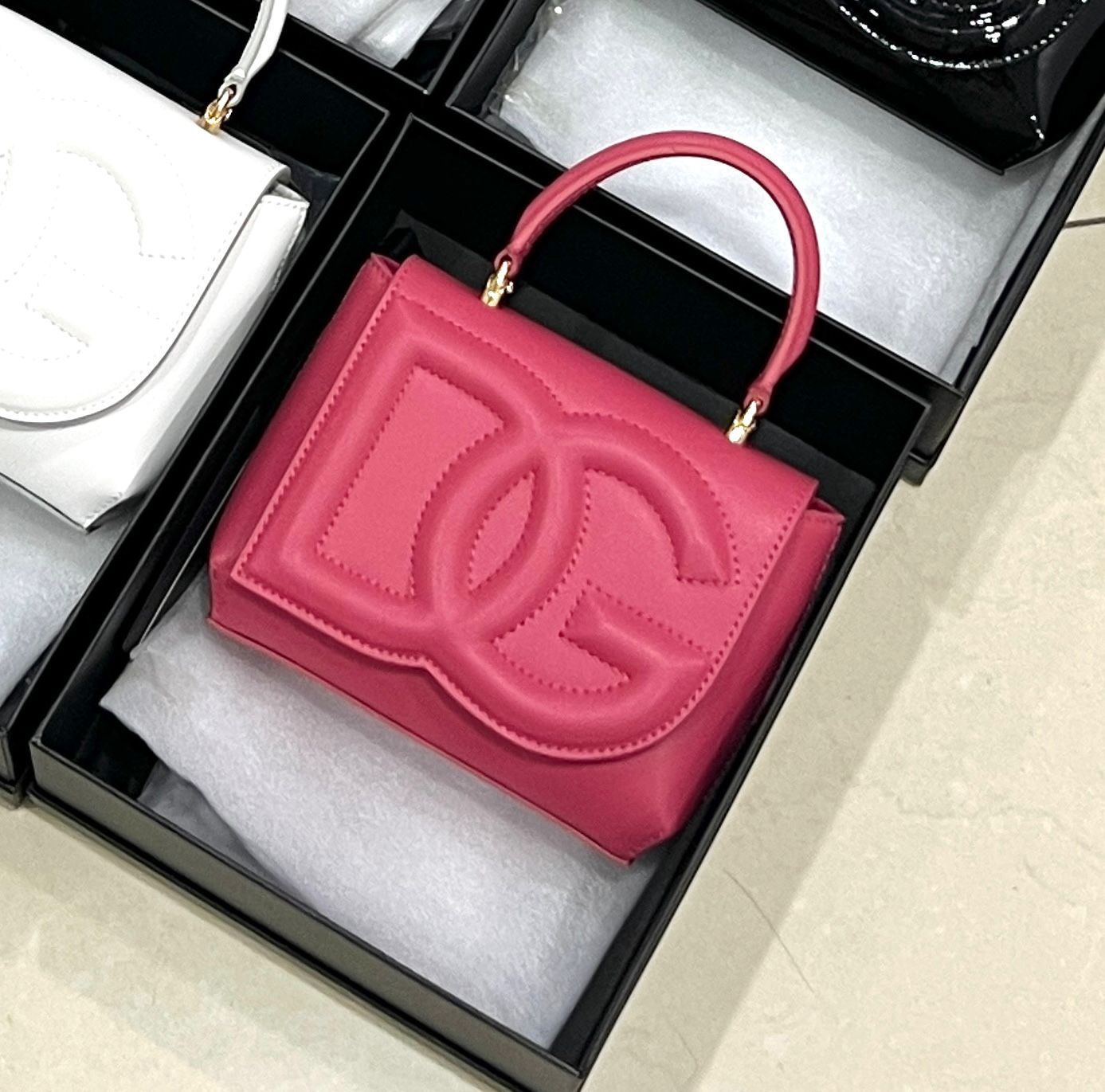 Dolce & Gabbana mini DG Daily tote bag in pink calf leather with an embossed DG logo. image 1