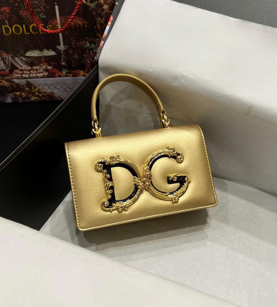 Dolce & Gabbana DG Girls top handle or shoulder bag in metallic gold leather with a Baroque-style DG logo. image 1