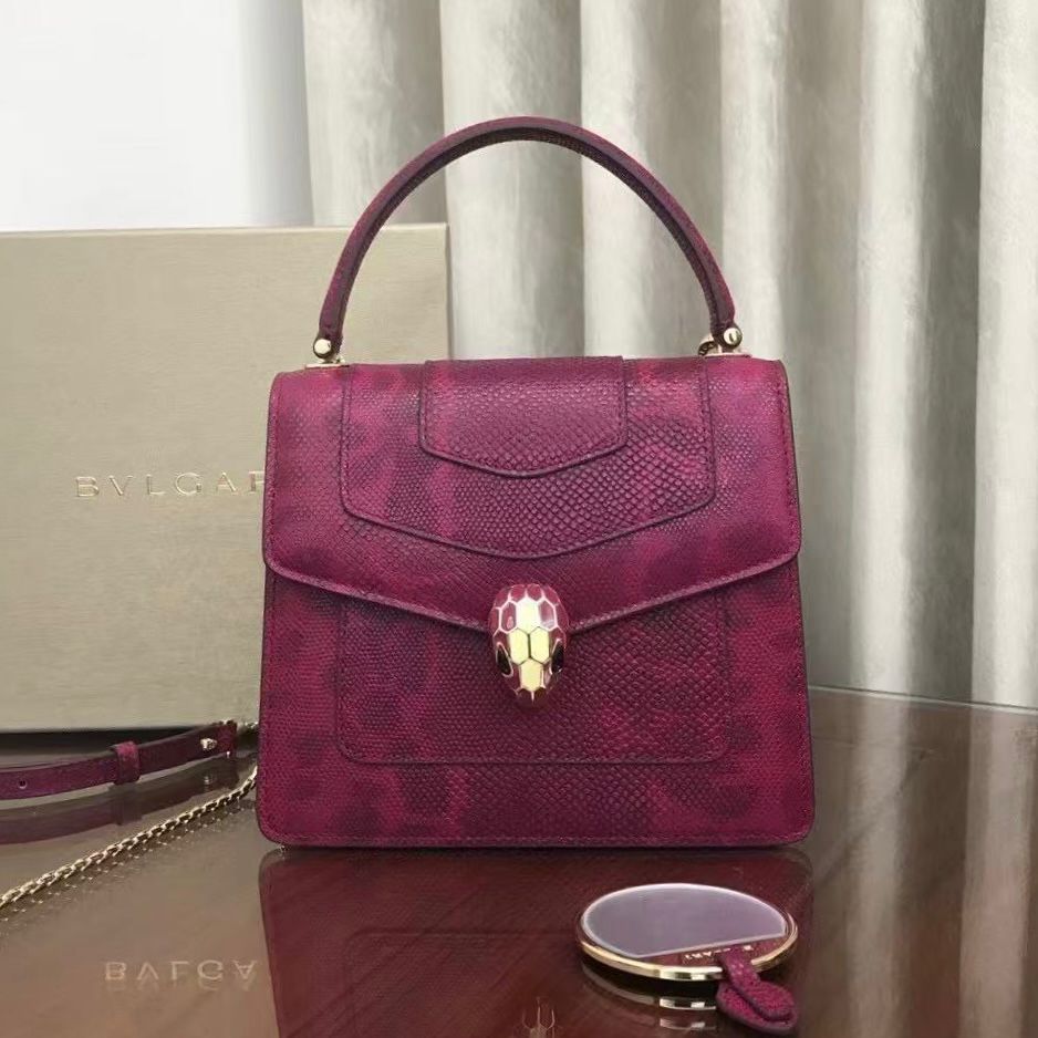 Bvlgari Serpenti Forever small top handle bag in a fuchsia or magenta color with a snakeskin-effect finish. image 1