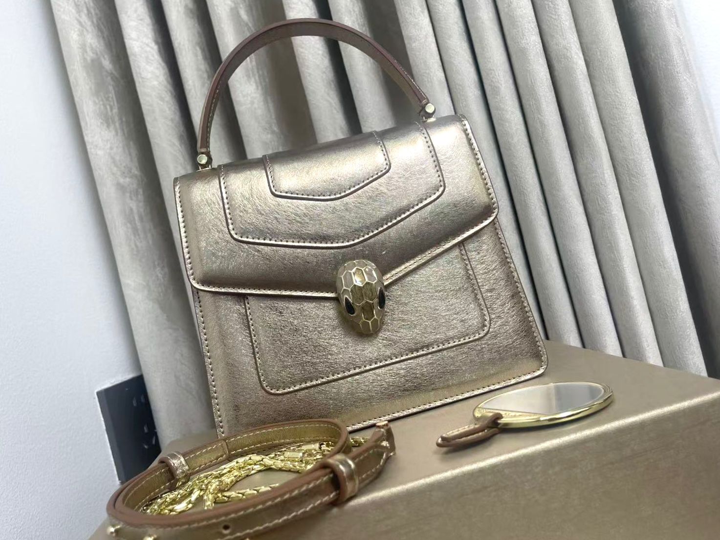 Bulgari Serpenti Forever small top handle bag in milky opal beige metallic karung leather. image 1