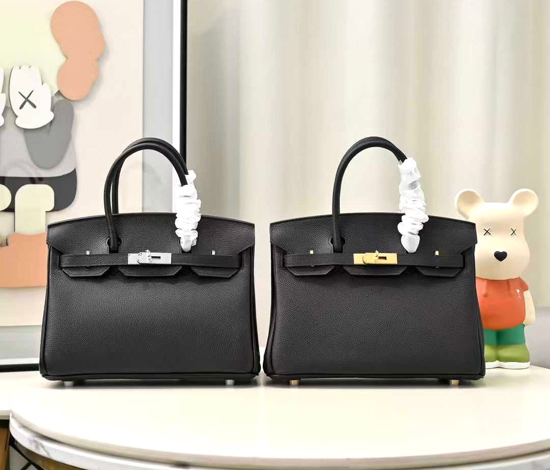 Herm?s Birkin bags in Togo leather, the one on the left has palladium/silver hardware and the one on the right has gold hardware. image 1