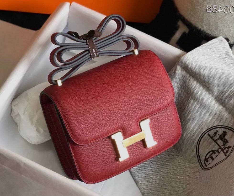 Herm?s Constance bag in a red tone, likely Rouge Casaque or Rouge Grenat, crafted in durable Epsom leather with gold-tone hardware. image 1