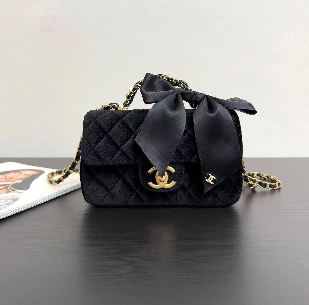 Chanel Fall-Winter 2025/26 Mini Flap Bag with Top Handle in black velvet with a silk bow and gold-tone metal hardware. image 1
