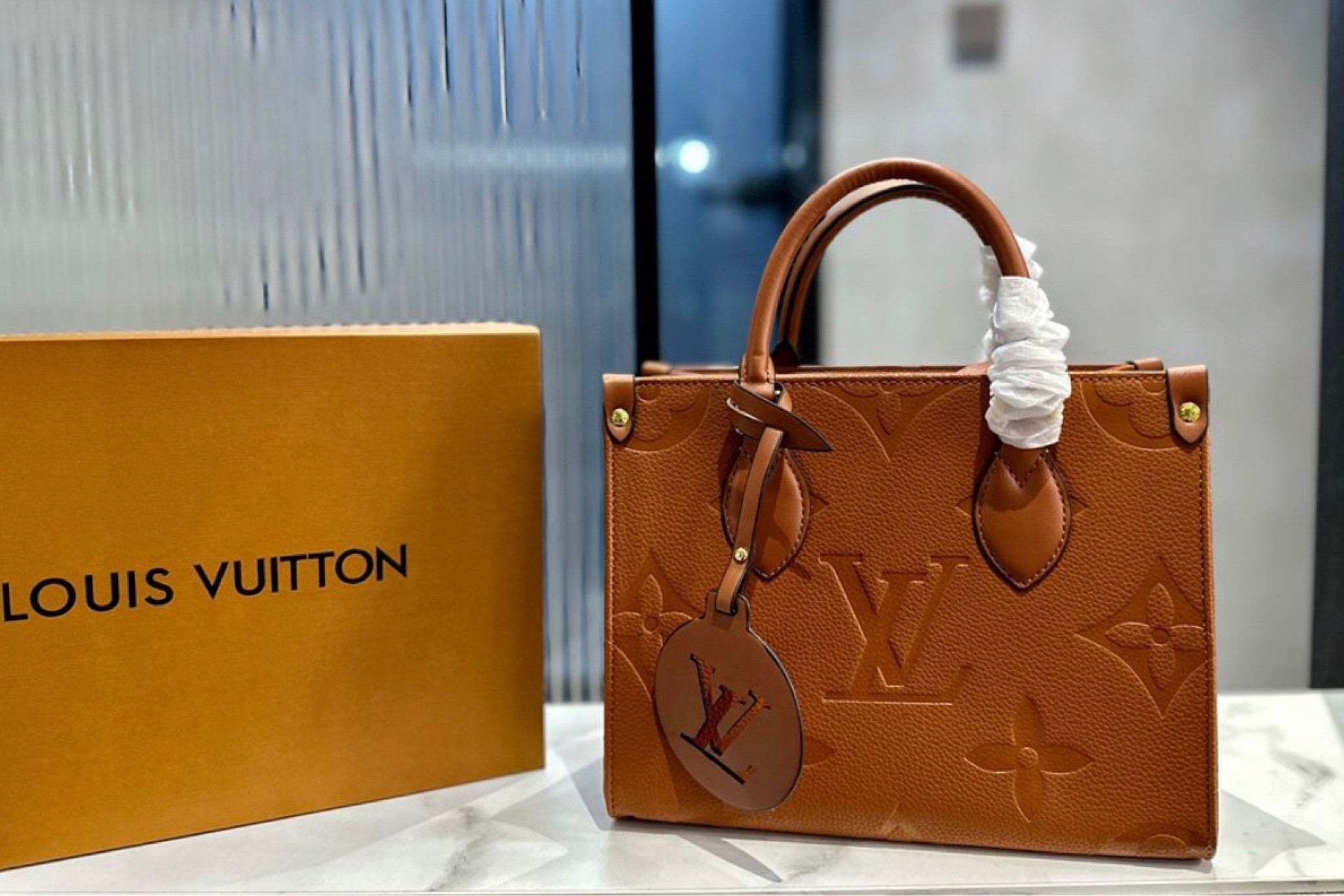 Louis Vuitton OnTheGo PM tote bag in the natural Monogram Empreinte leather. image 1