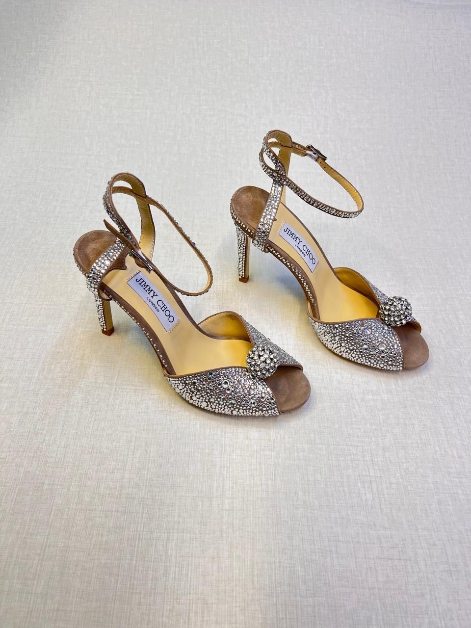 Jimmy Choo Sacora 100 crystal-embellished suede sandals in a nude or light gold color. image 1