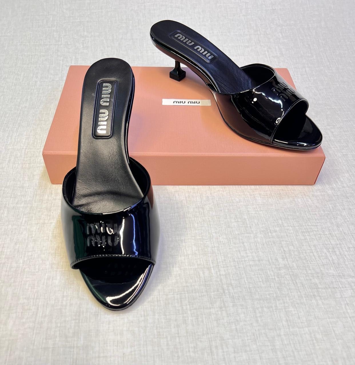 Miu Miu black patent leather mules. image 1