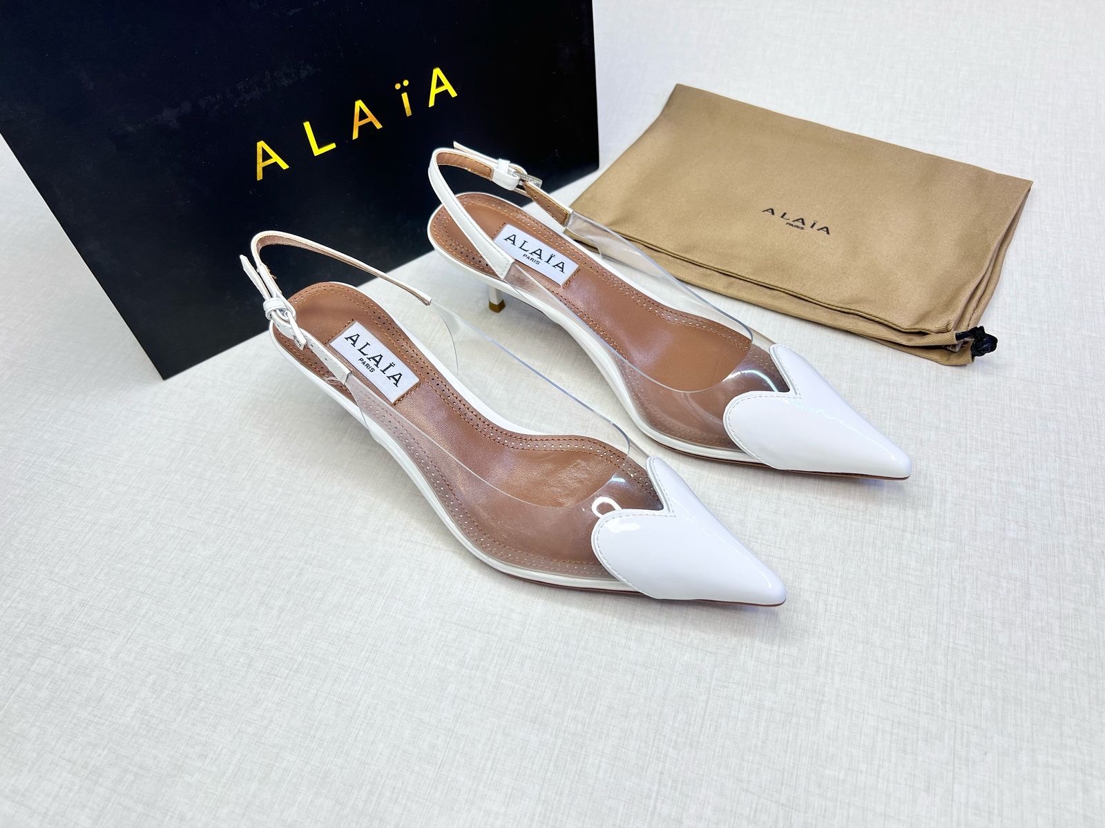 Alaïa Le Cœur slingback pumps in white patent leather and transparent PVC image 1