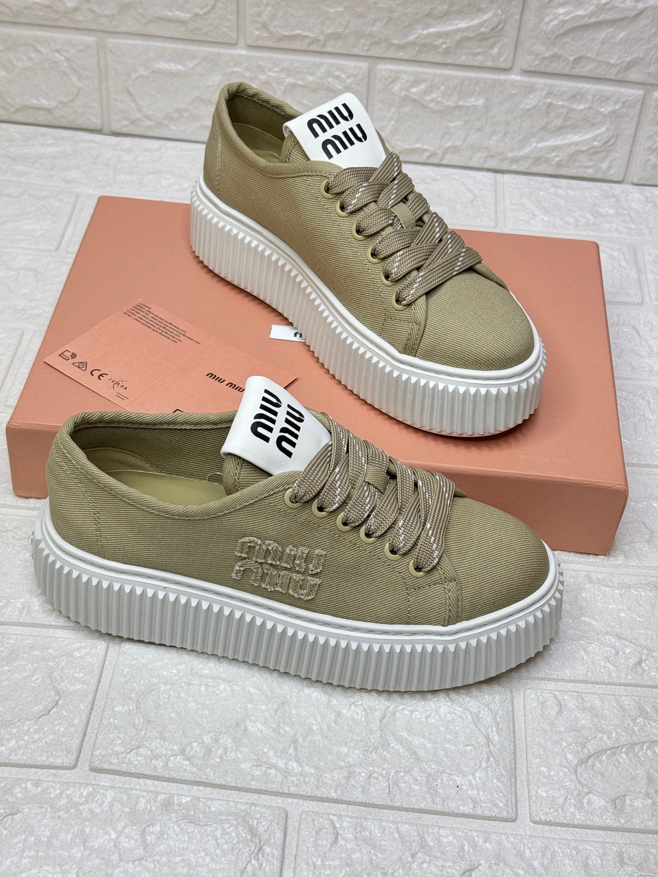 Miu Miu canvas low-top platform sneakers with an embroidered logo image 1