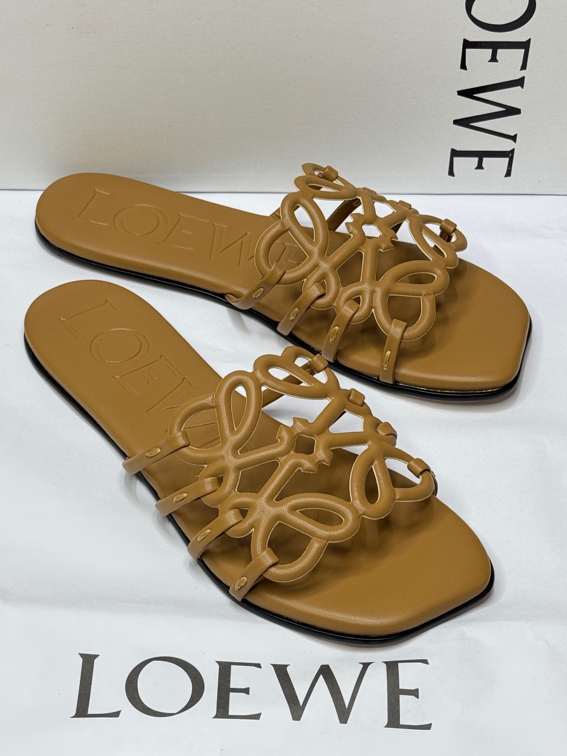 Loewe Petal Anagram slides in camel-brown calfskin leather. image 1