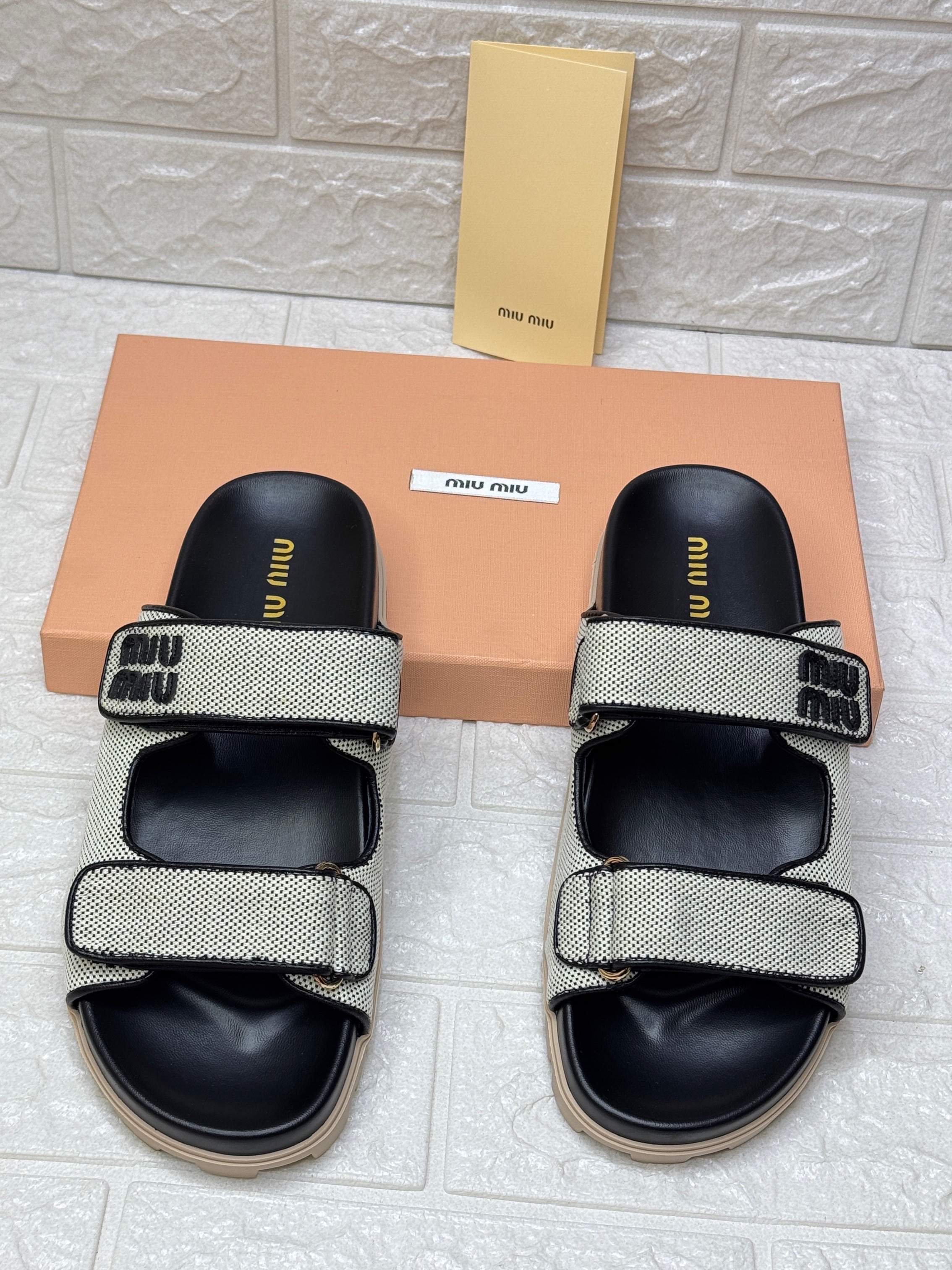 Miu Miu touch-strap raffia sandals in a sand beige and black colorway. image 1