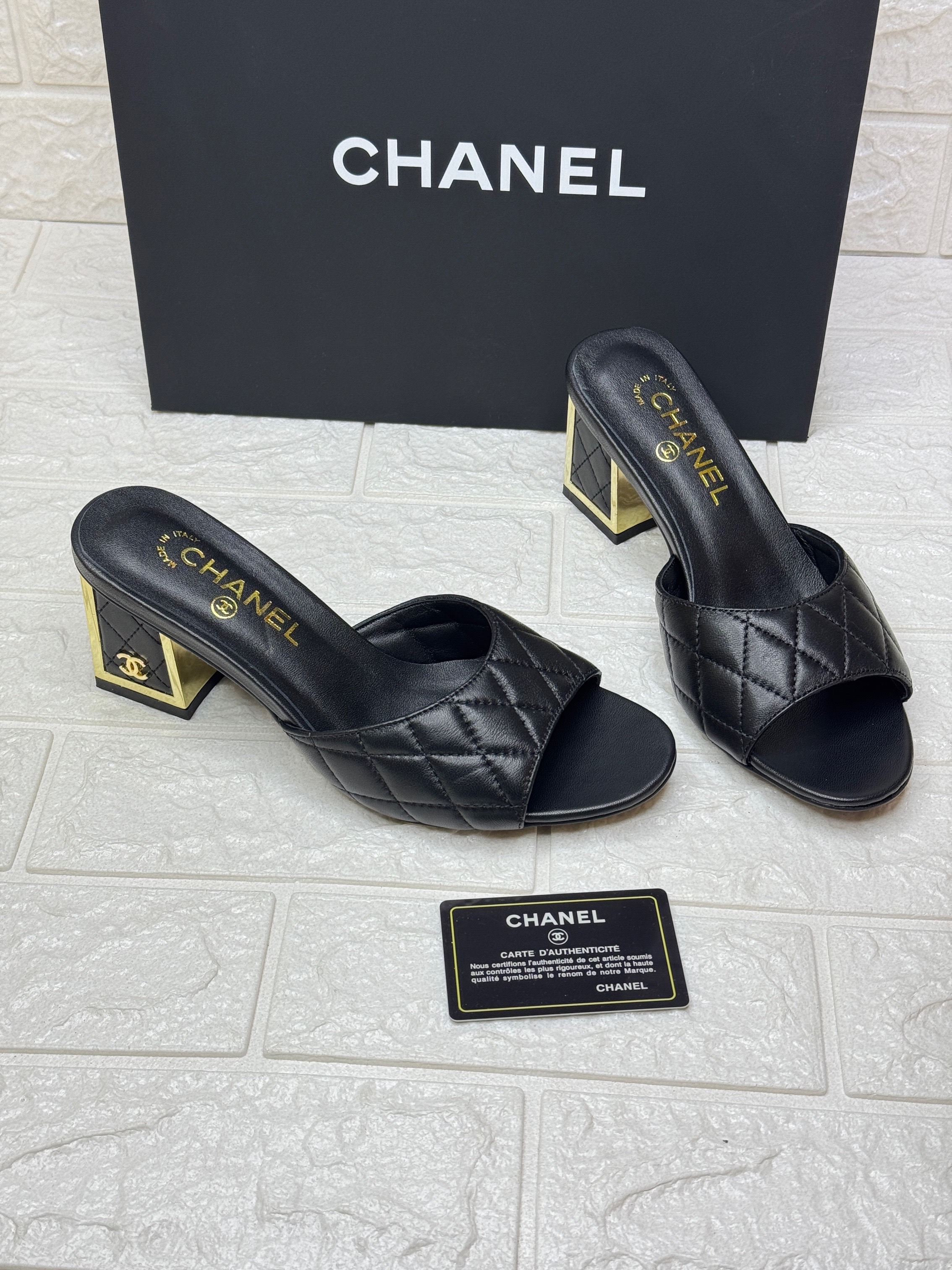Chanel black and gold quilted leather mules with an iconic logo block heel. image 1