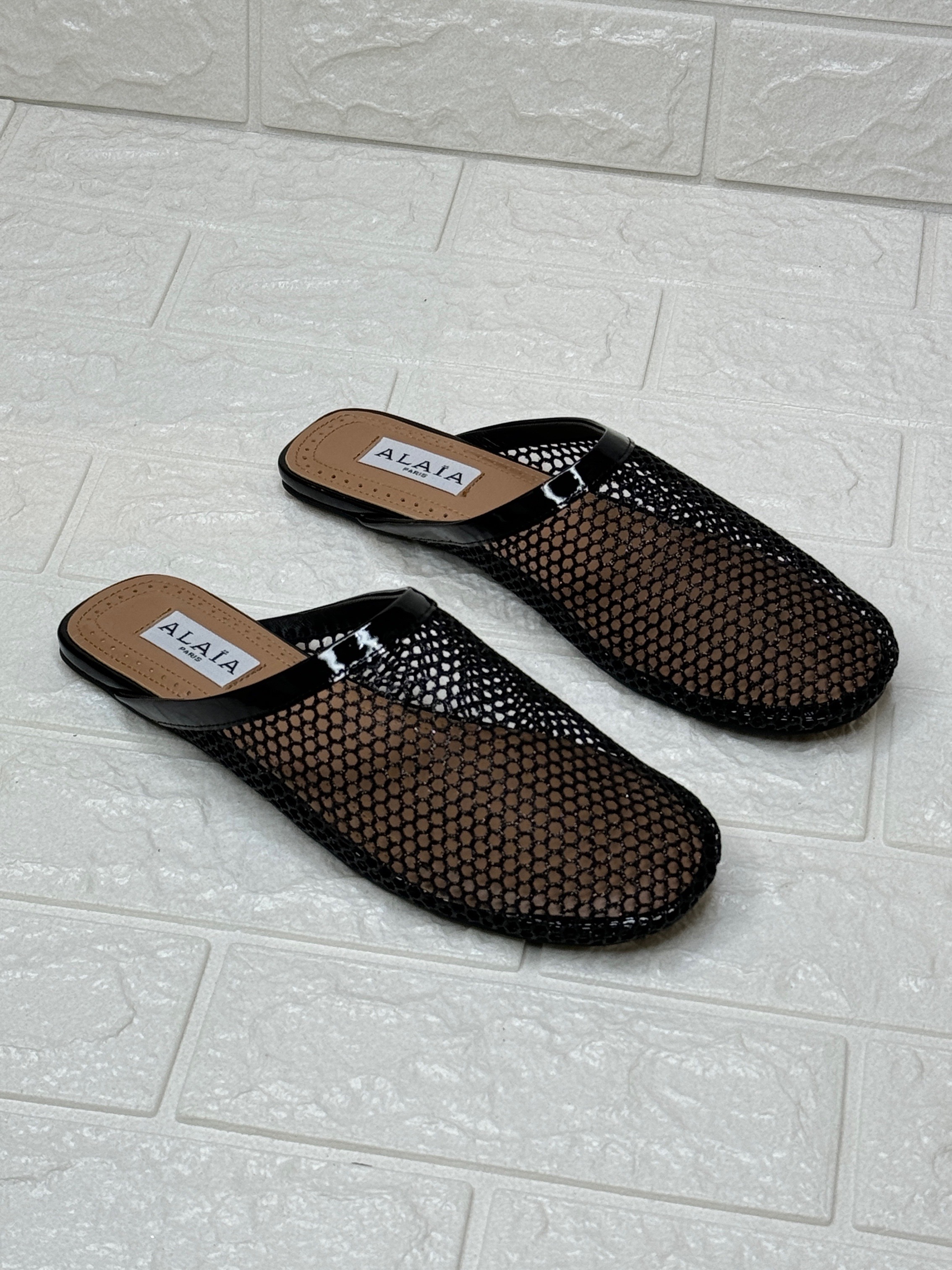 Alaïa Ballet Flat Mules in fishnet mesh and patent leather. image 1