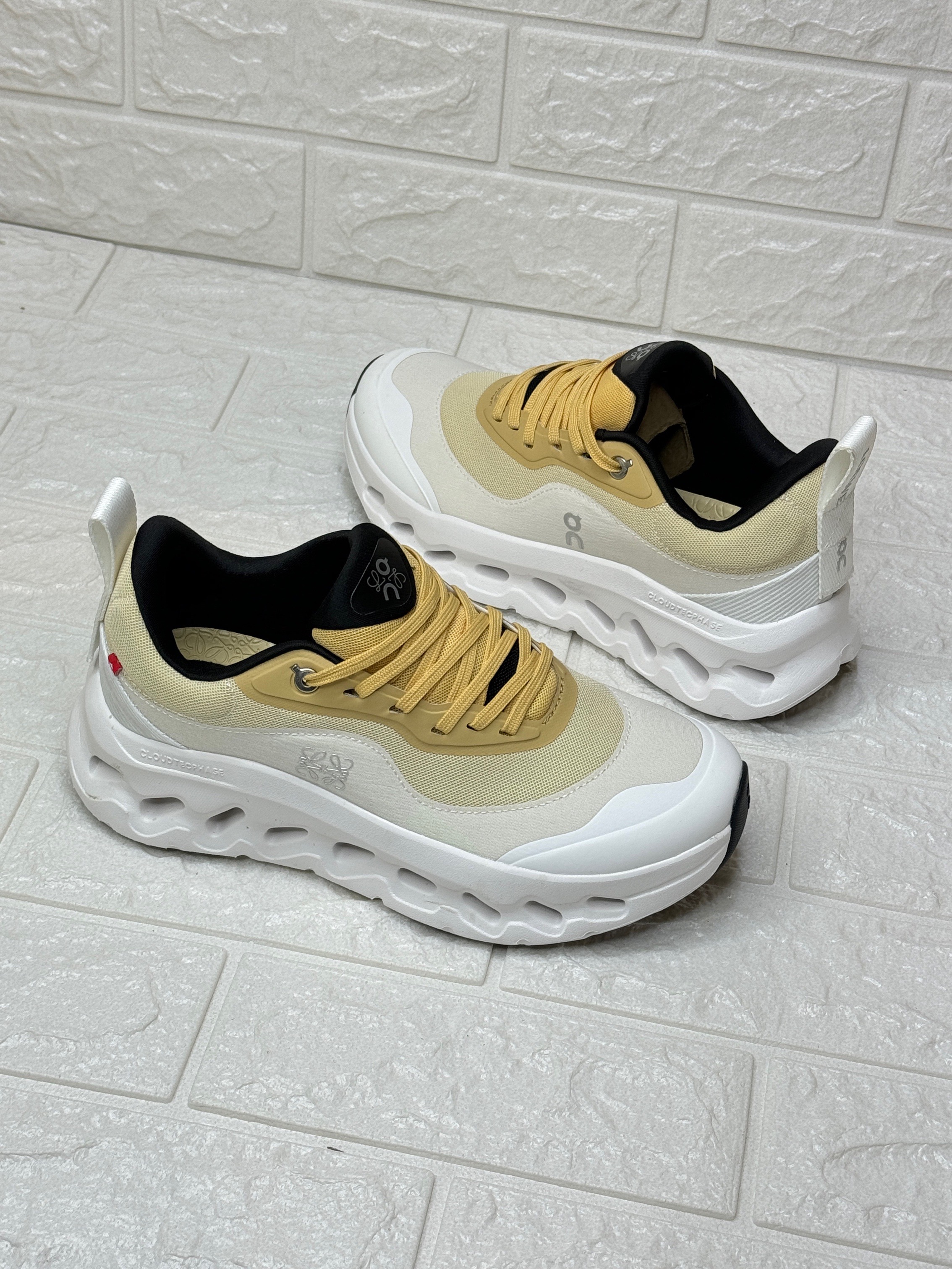 Loewe X Cloudtilt running shoe with a white and yellow colorway image 1