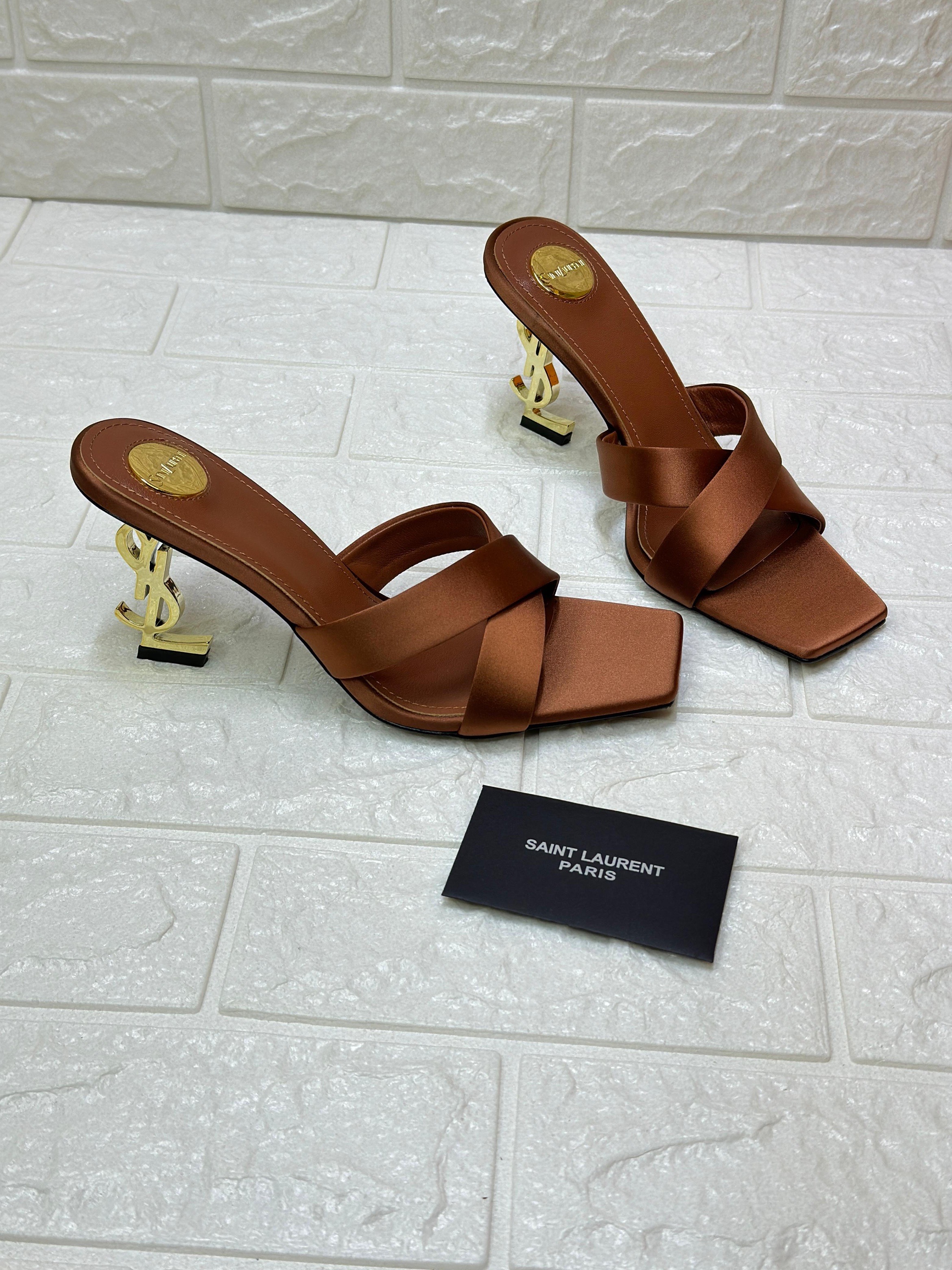 Saint Laurent Opyum 85 mule sandals in brown satin crepe with the iconic gold-tone YSL monogram heel. image 1