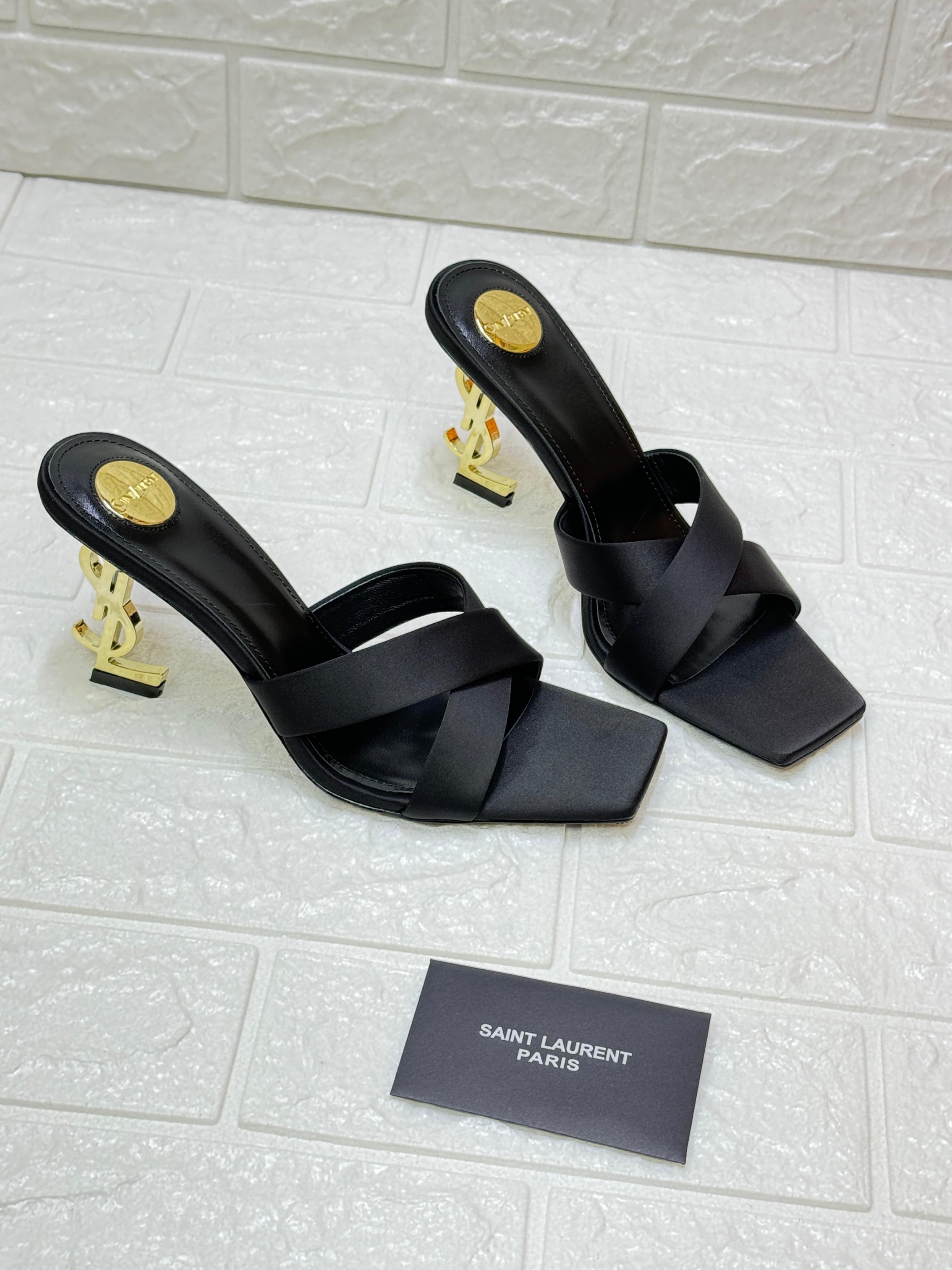 Saint Laurent Opyum 85 mule sandals in black satin crepe with a bronze-tone metal Cassandre heel. image 1