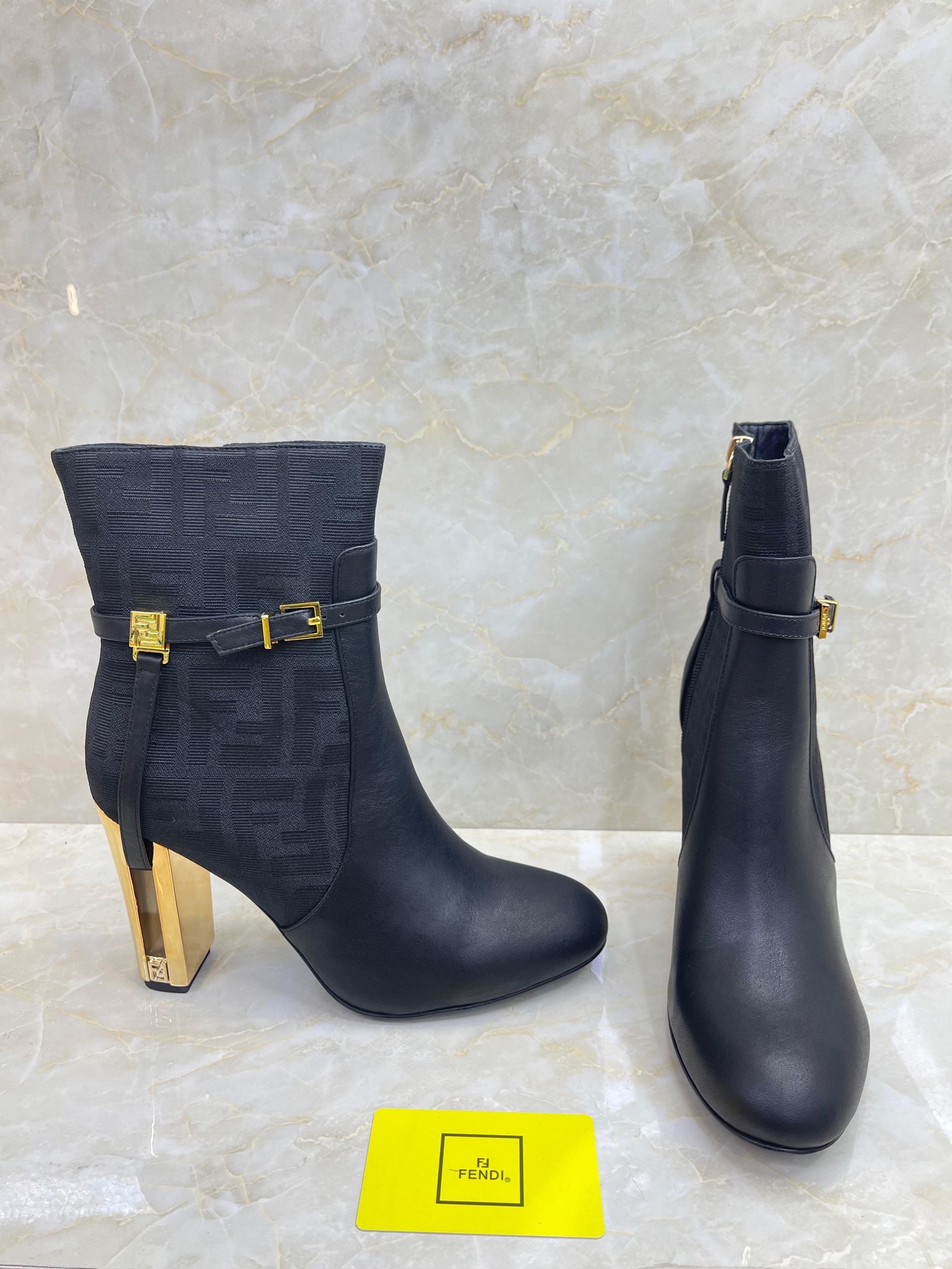 Fendi Delfina 105mm leather ankle boot with a gold-tone cut-out block heel and signature FF motif buckle strap. image 1