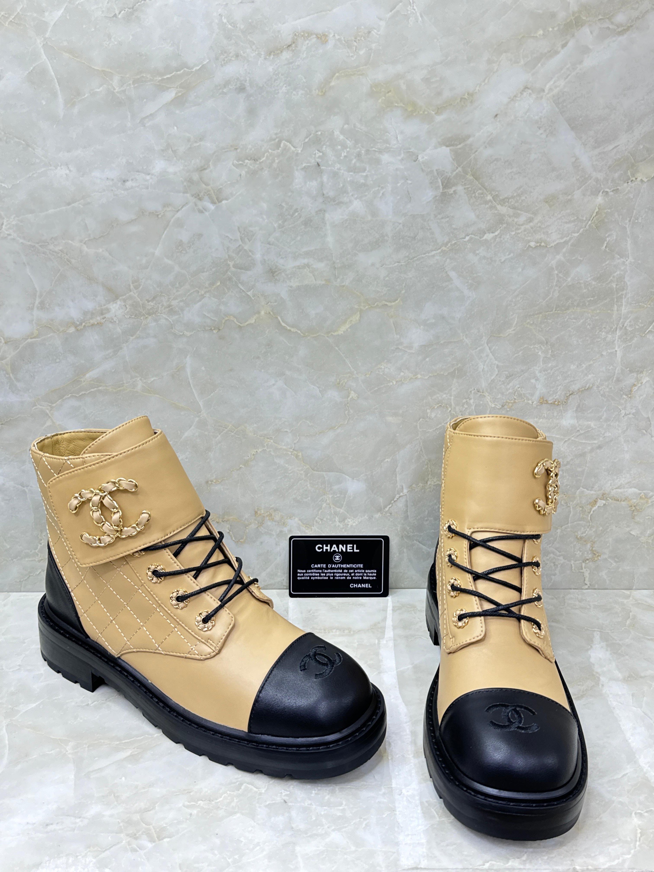AChanel beige and black quilted leather chain combat boots. image 1