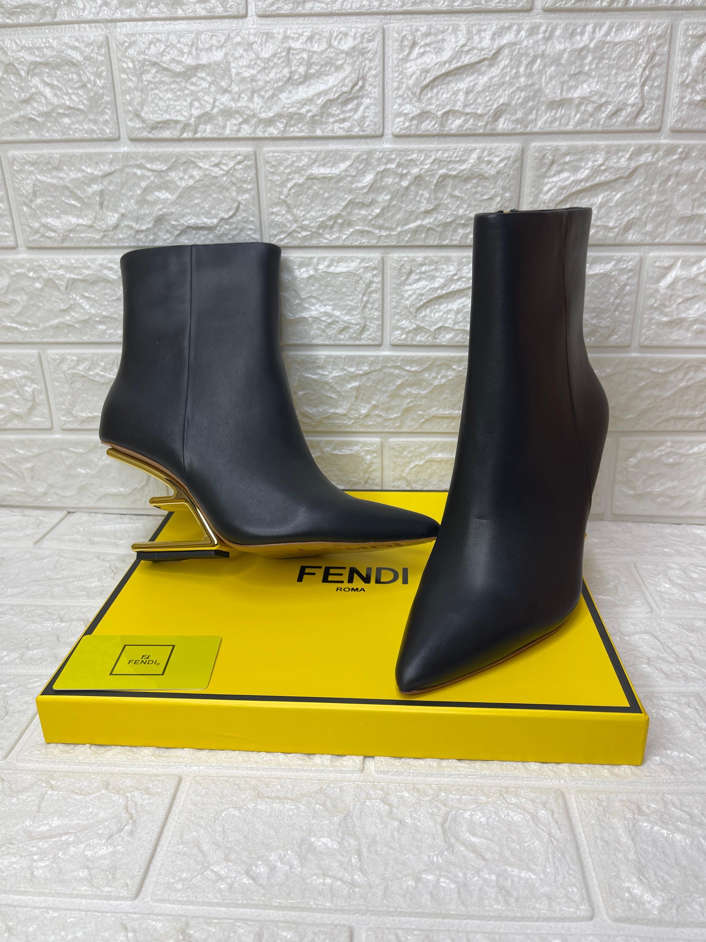 Fendi First 105mm black leather ankle boot with a gold-tone F-shaped heel. image 1
