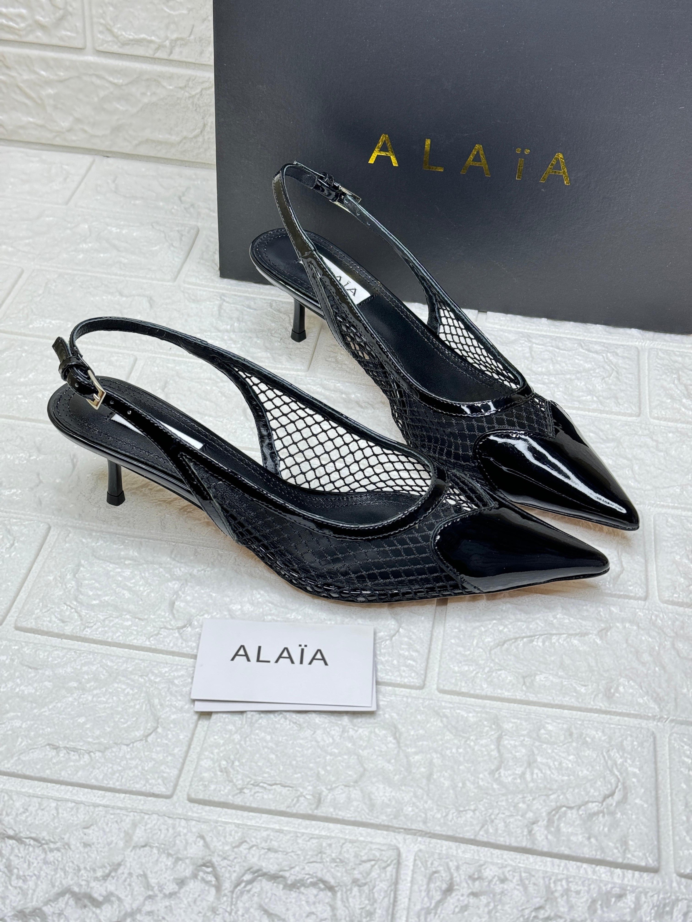 Alaïa Le Cœur 55mm slingback pumps in black patent leather and mesh. image 1