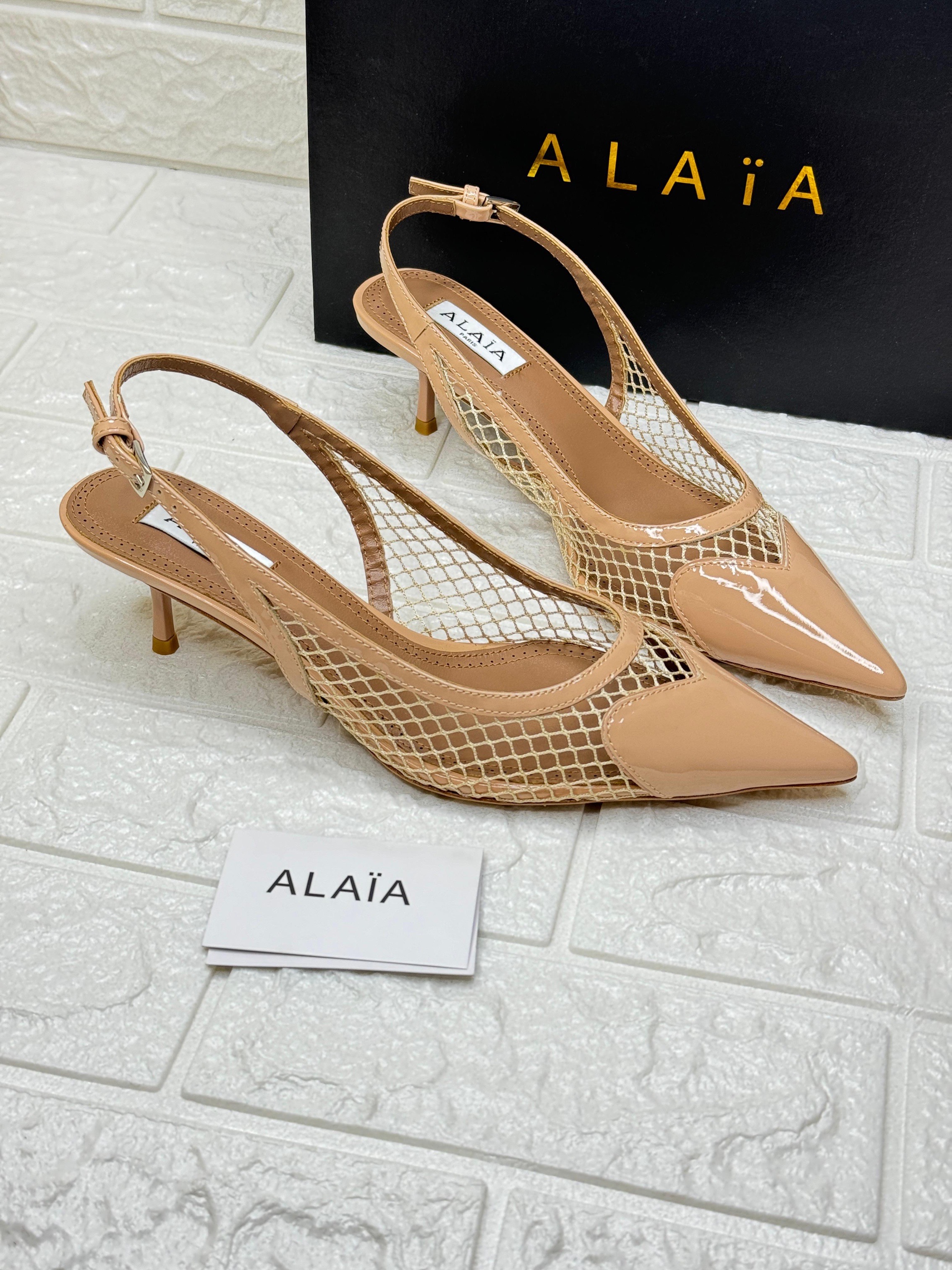 Alaïa Le Cœur patent leather and PVC mesh slingback pump. image 1