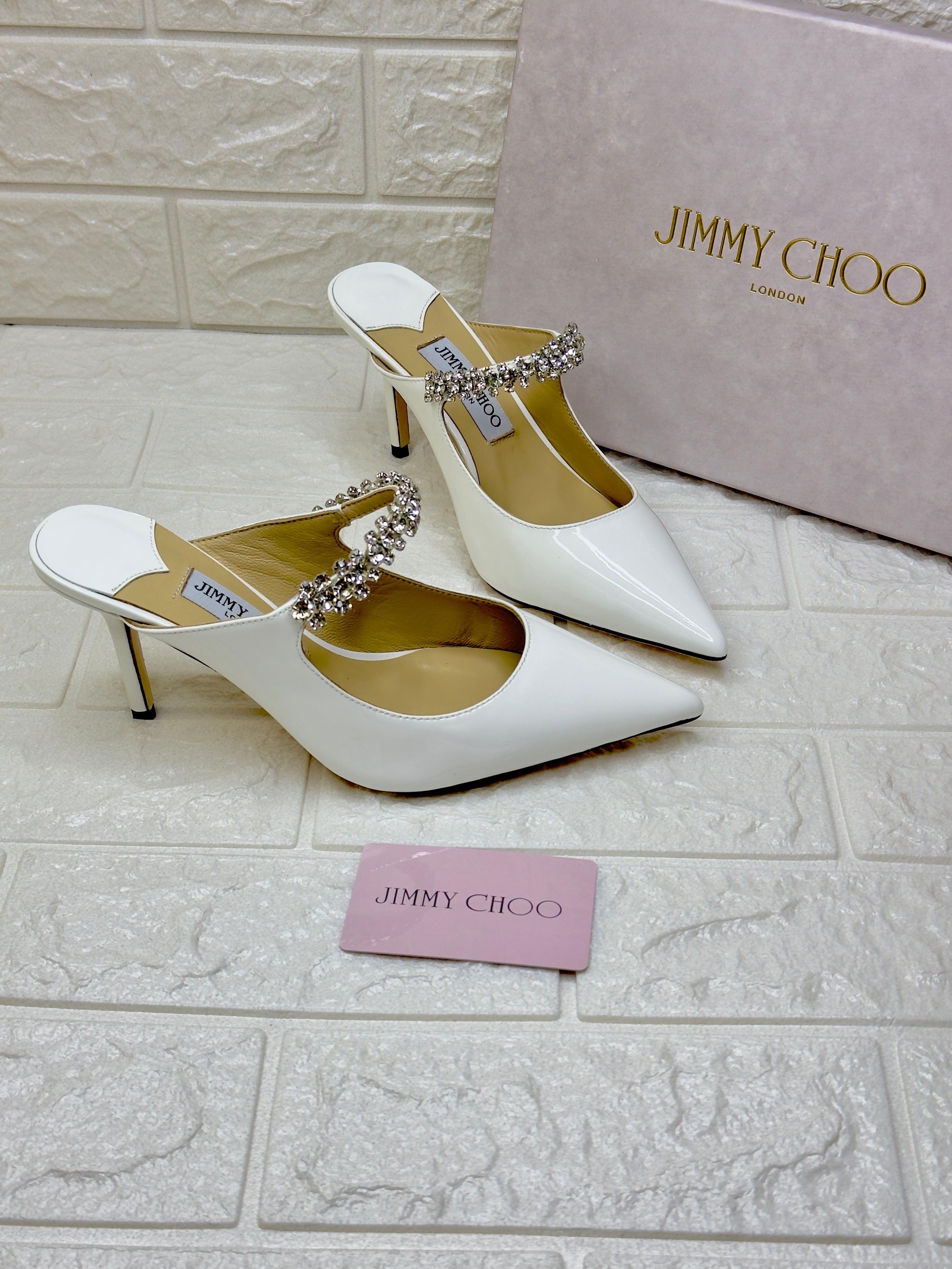 Jimmy Choo Bing mules in white or linen patent leather with a crystal-embellished strap. image 1