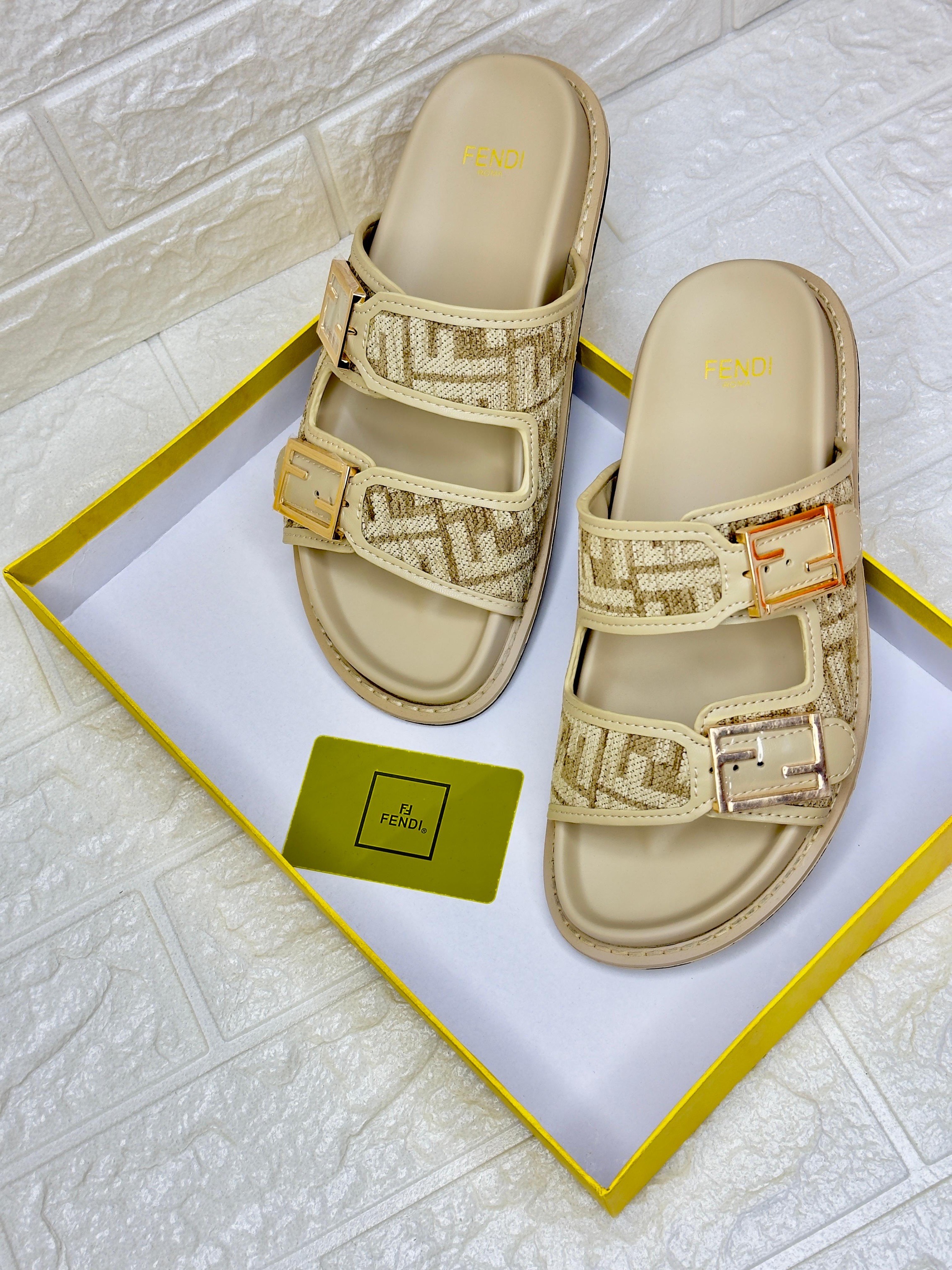 Fendi Feel FF-logo buckle sandals in a beige and brown colorway. image 1