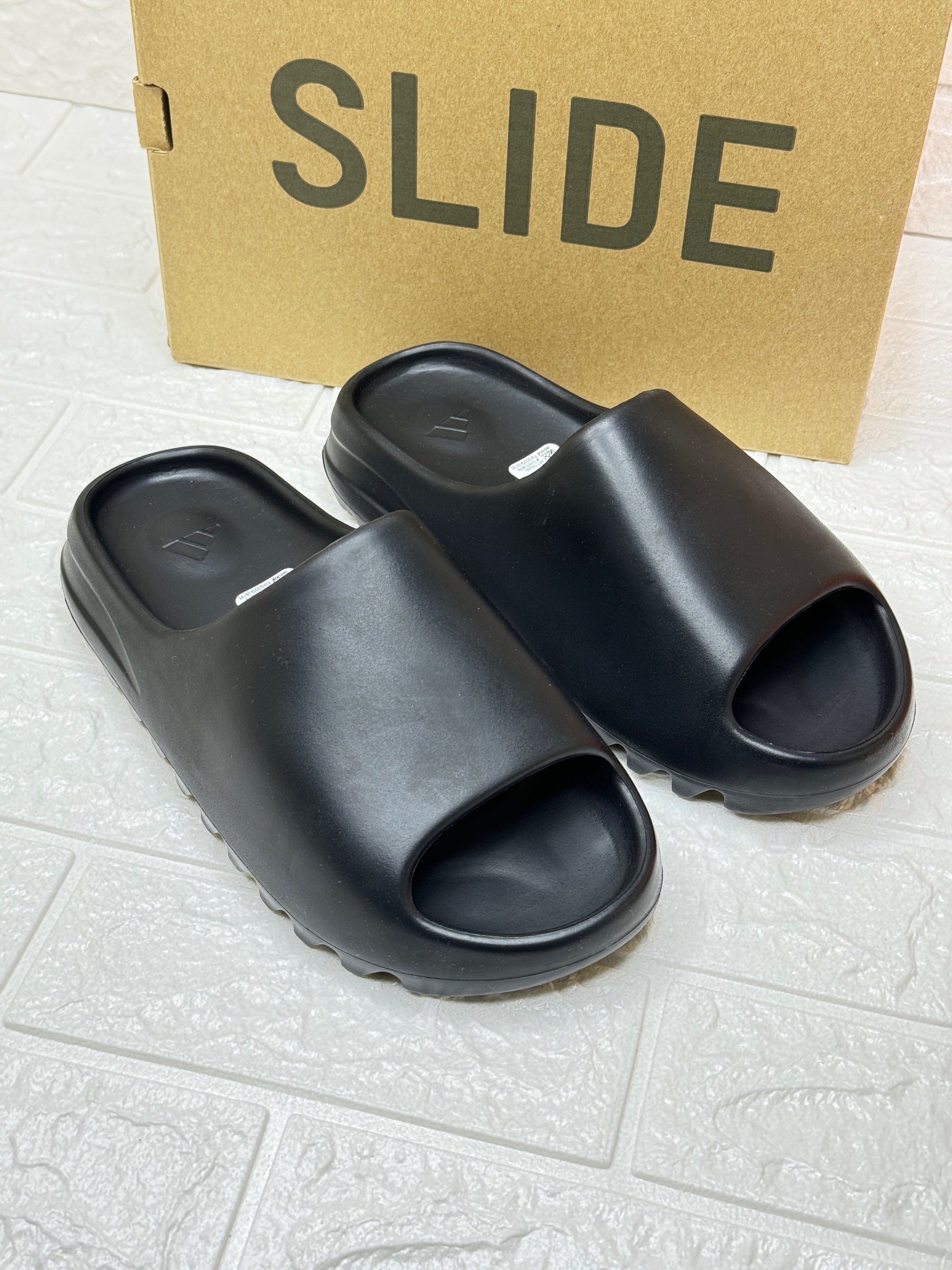 Adidas Yeezy Slide in the Onyx colorway. image 1