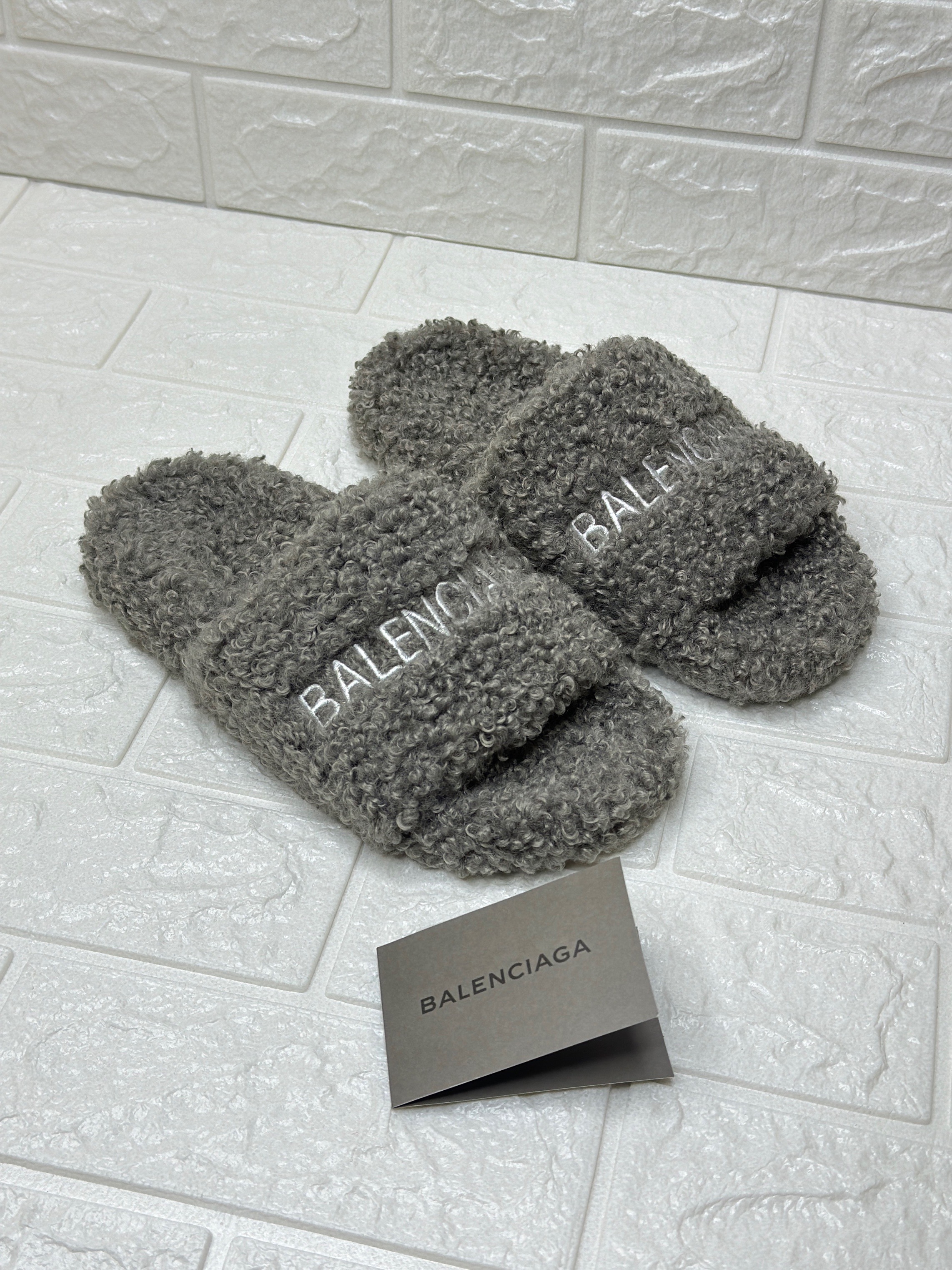 Balenciaga Furry Slide Sandals in a grey/neutral faux shearling finish with the Political Campaign logo embroidery. image 1