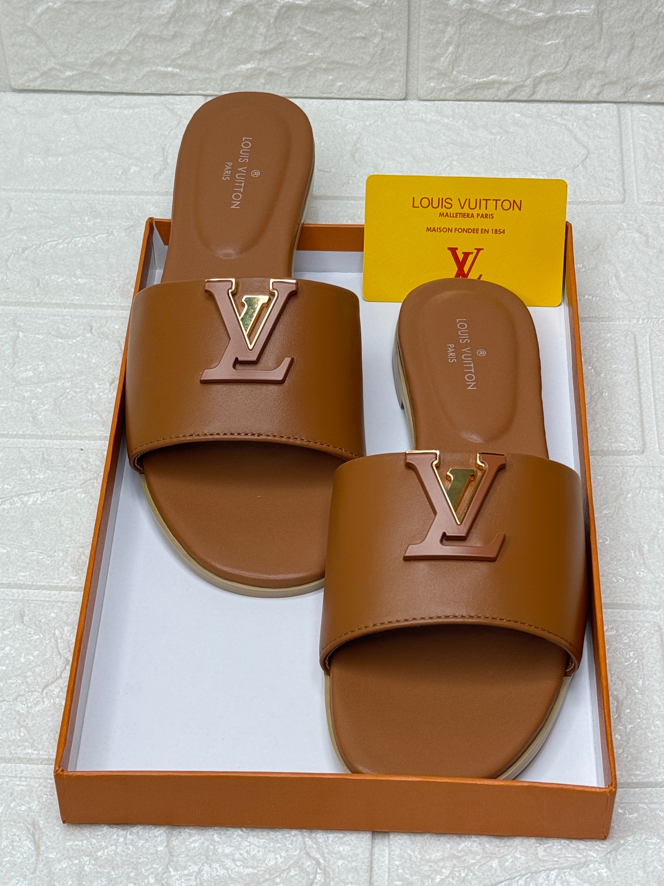 Louis Vuitton Capri flat mules in chocolate calfskin leather. image 1