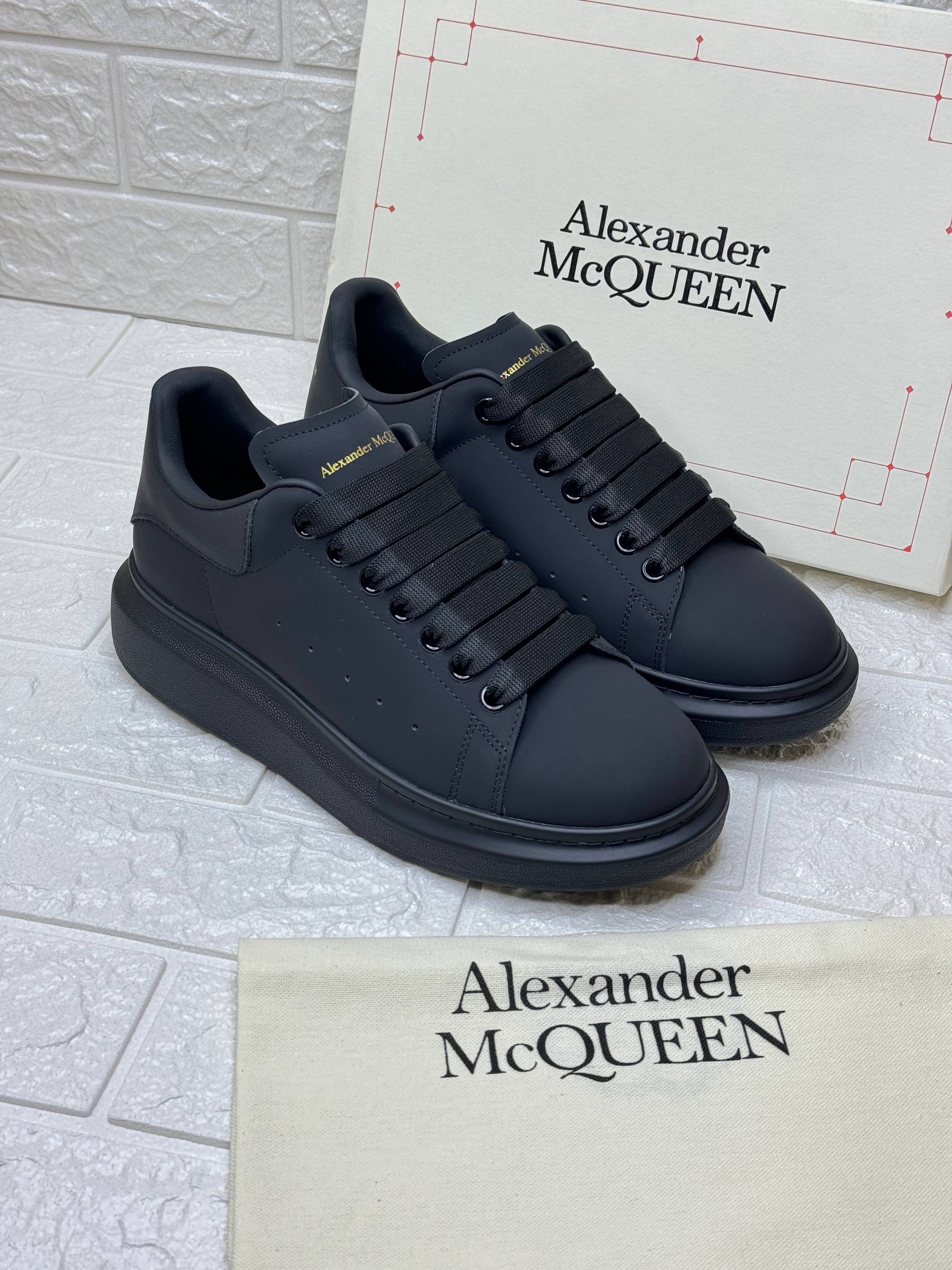 Alexander McQueen Men's Oversized sneakers in black calf leather with a tonal black oversized rubber sole. image 1