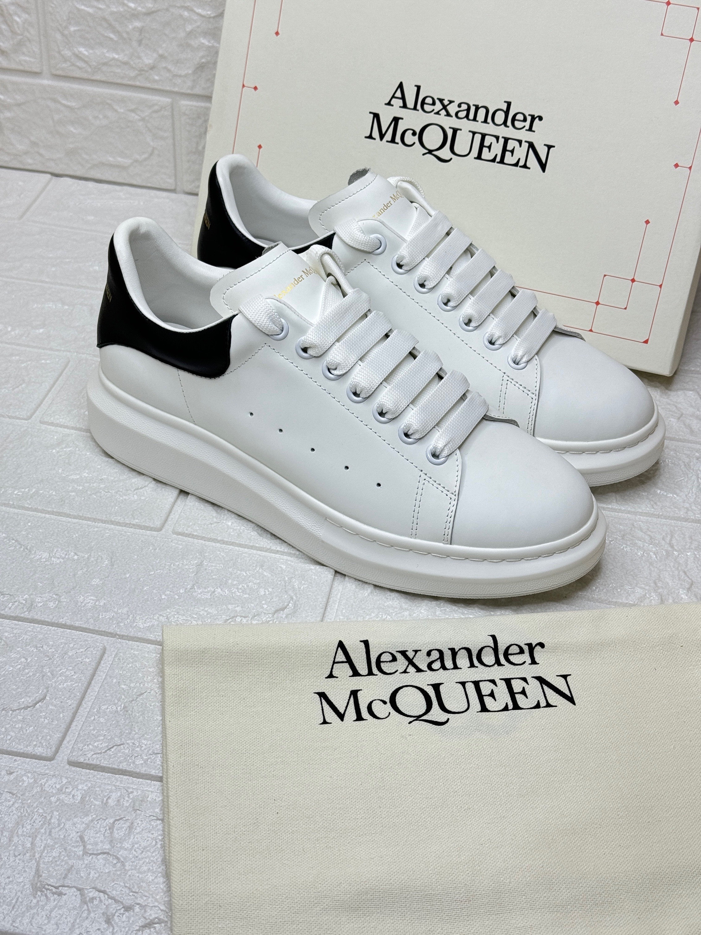 Alexander McQueen Oversized sneakers with a white calf leather upper and a black contrasting heel tab. image 1