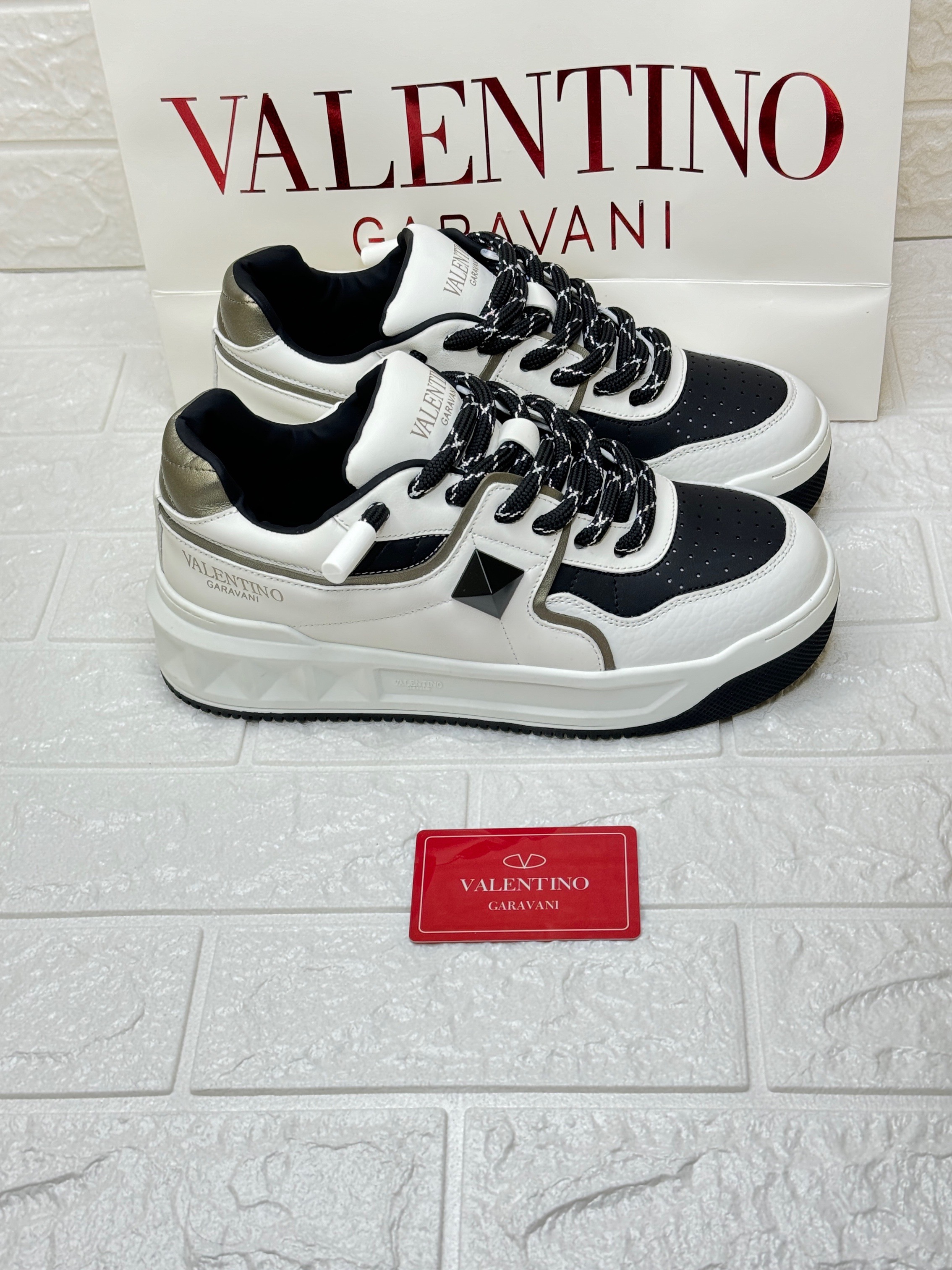 Valentino Garavani One Stud low-top nappa leather sneakers in white and black. image 1