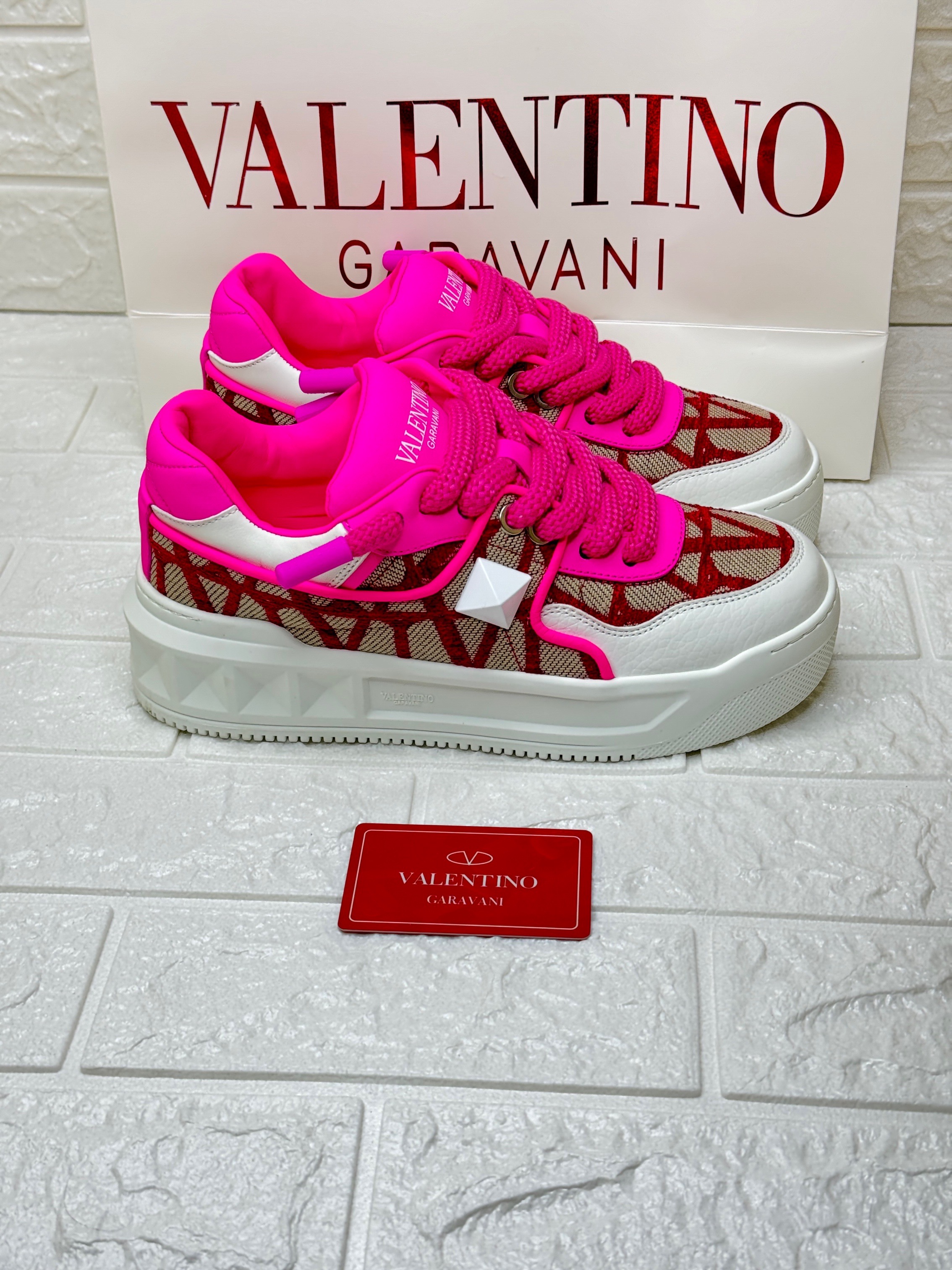 Valentino Garavani One Stud XL low-top sneakers in a hot pink and Toile Iconographe pattern. image 1