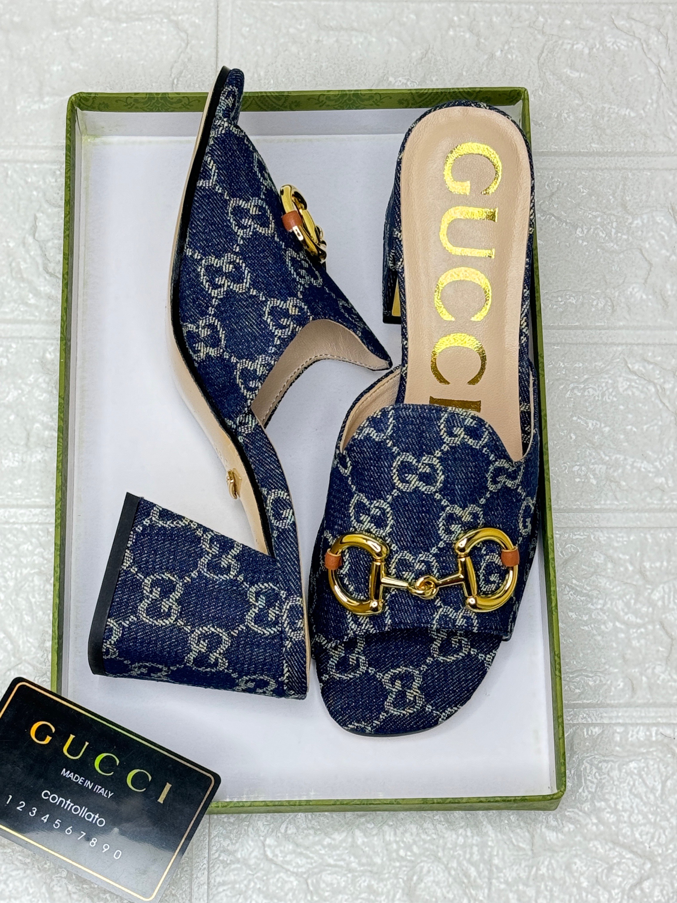 Gucci heeled mules featuring the brand's signature interlocking GG symbols and Horsebit hardware image 1