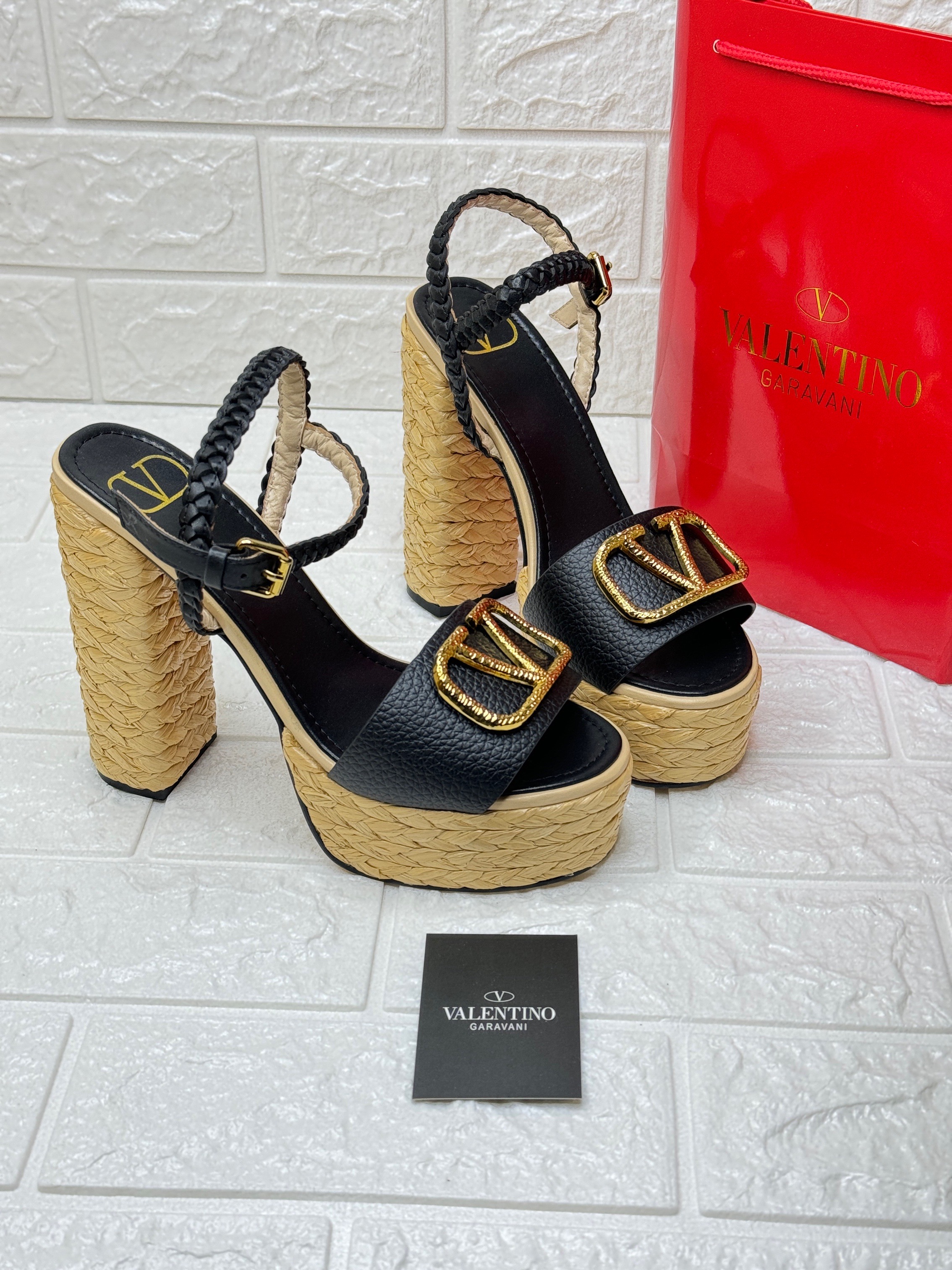 Valentino Garavani VLogo Signature platform sandal in black leather with a woven raffia-look heel and platform. image 1
