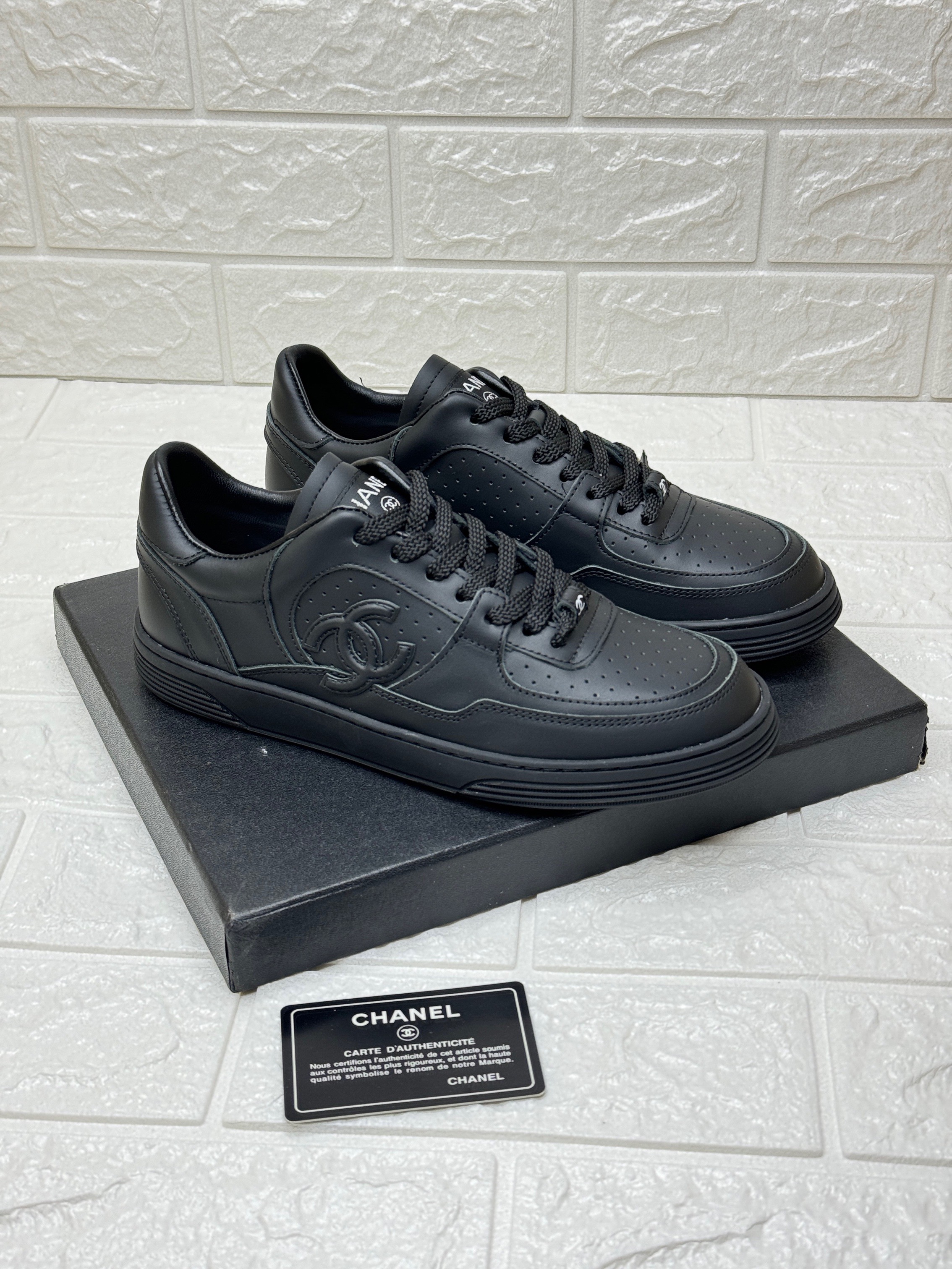 Chanel all-black sneakers with the CC logo. image 1