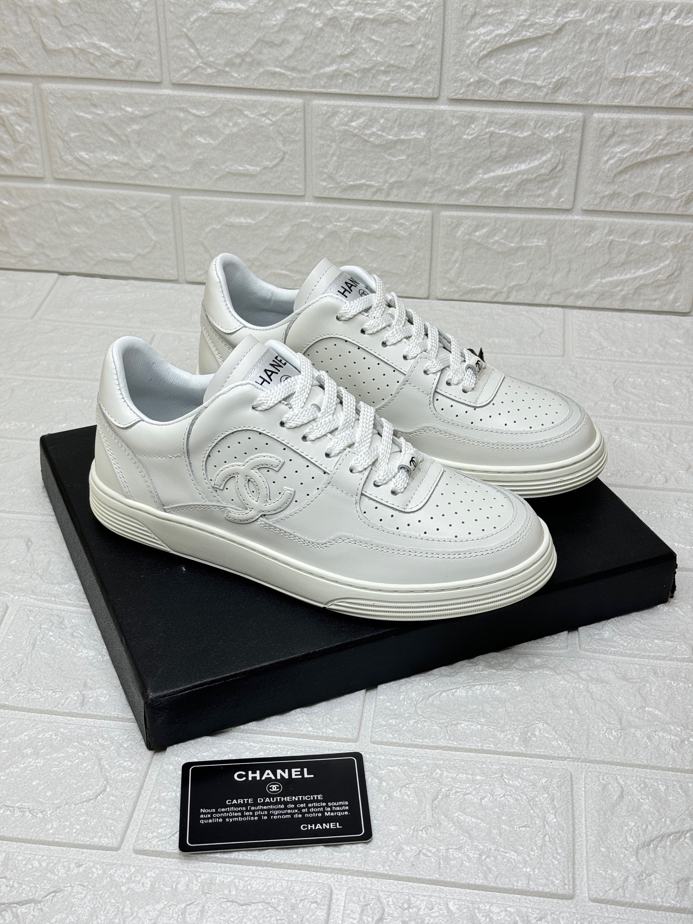 Chanel leather sneakers with an interlocking CC logo on the side. image 1