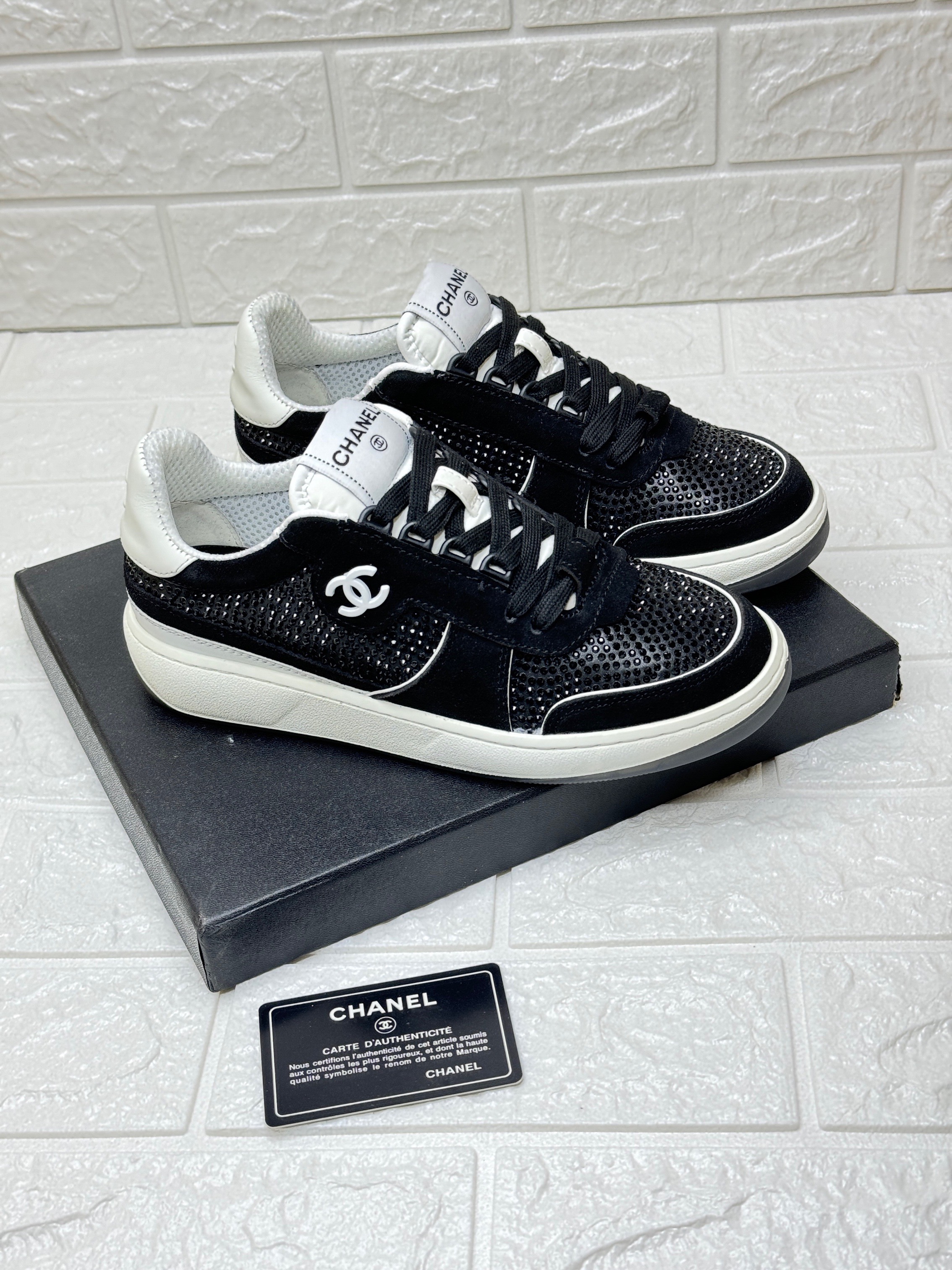 Chanel sneakers in black and white mesh, suede calfskin, and grained calfskin. image 1