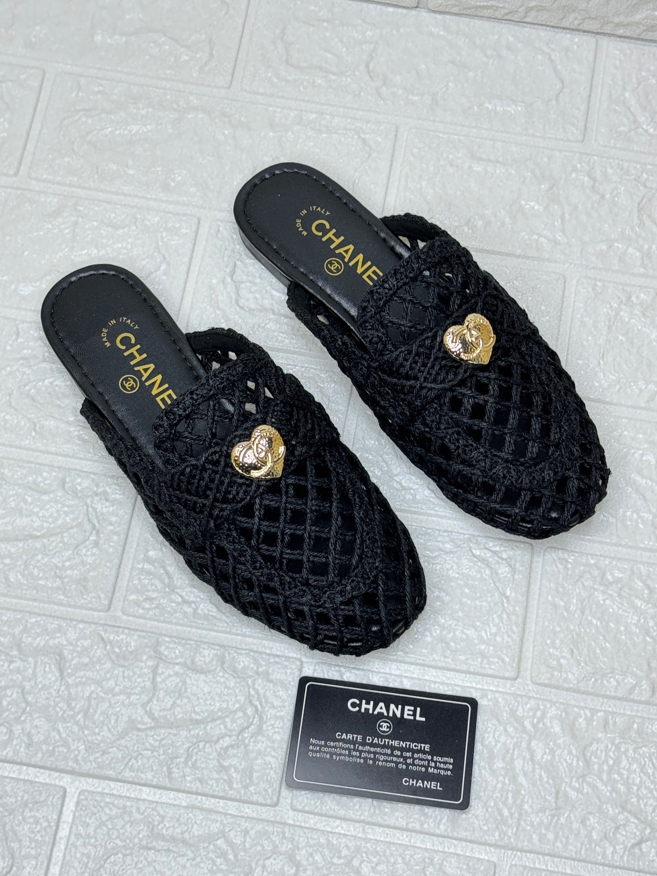 Chanel black quilted slides with gold-tone CC turnlock details. image 1