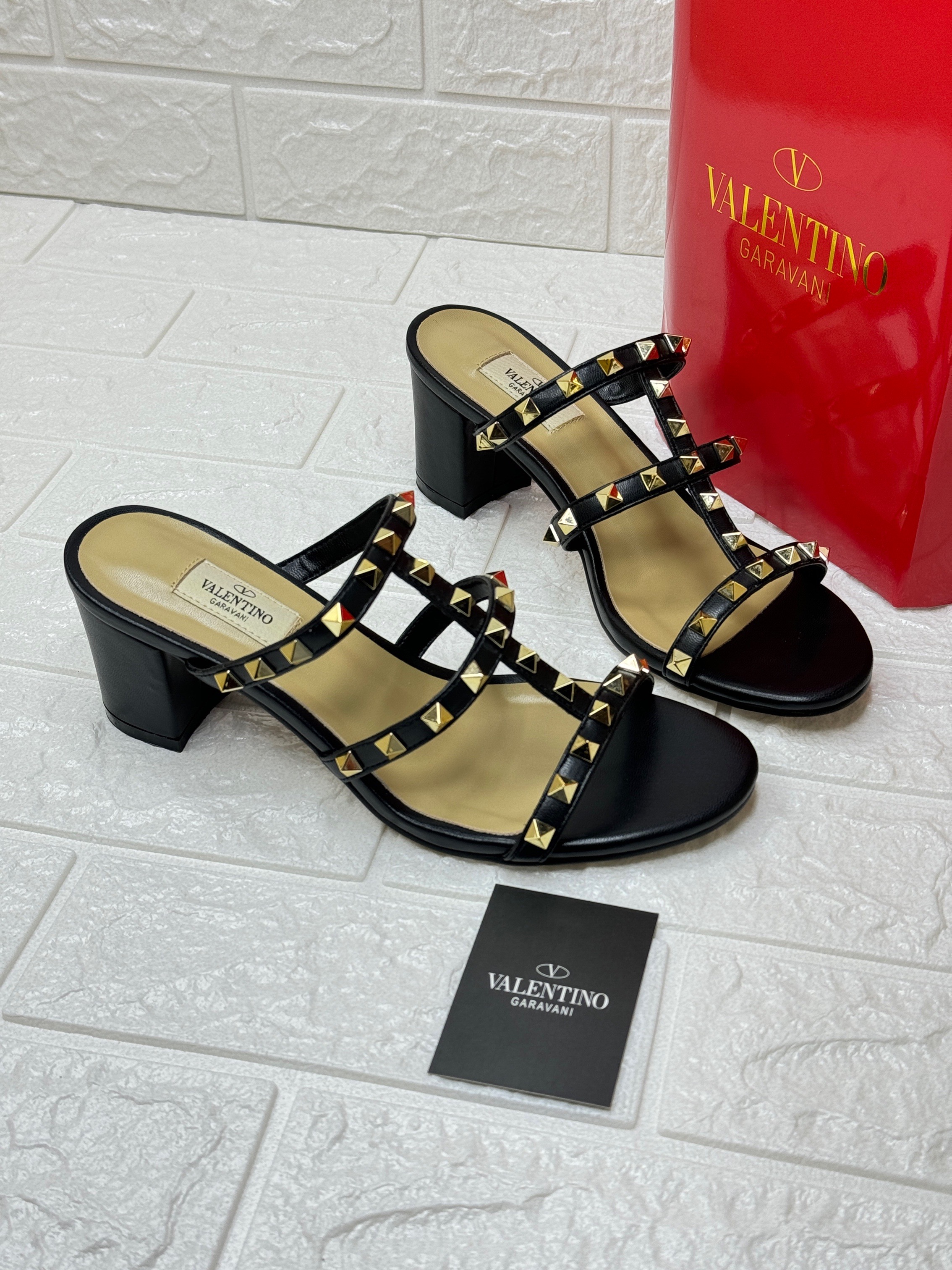 Valentino Garavani Rockstud 60 slide sandals in black calfskin leather with platinum-finish studs and a block heel. image 1